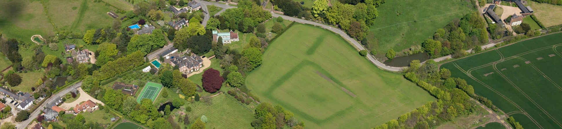 An aerial photograph showing standing buildings and cropmarks.