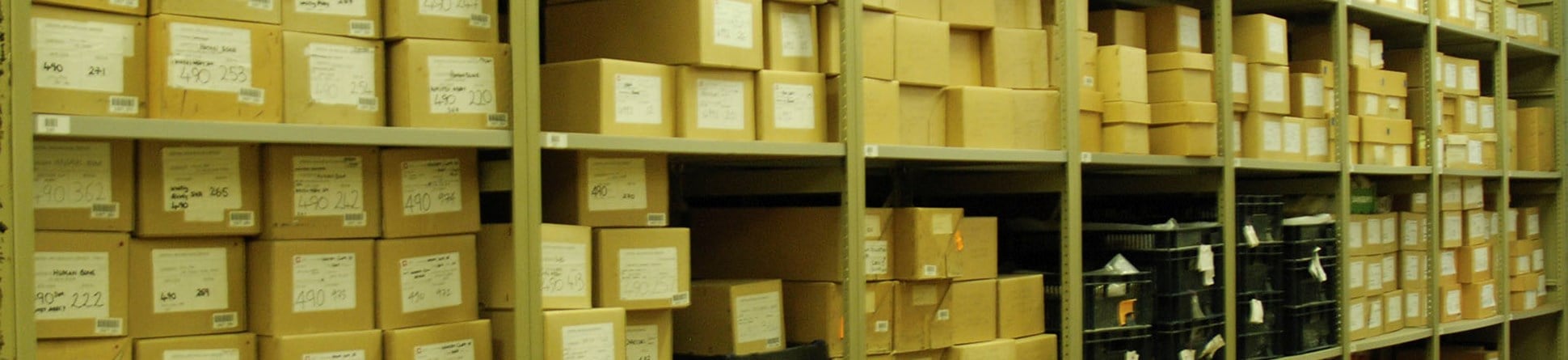 Labelled archive boxes on shelves within an archives store