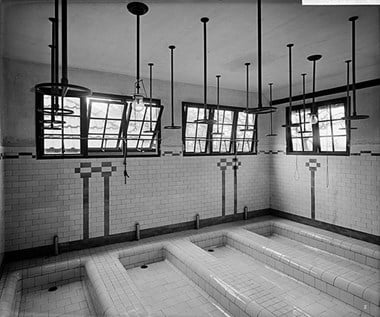 Interior of the baths at Thackley Open Air School, Bradford. Thackley Open Air School, located in Buck Wood, Thackley, was designed by R G Kirby for the Bradford Corporation. It had south facing open-fronted classrooms and was designed to provide education and care for children recovering from illnesses. It first opened to pupils in Summer 1908 and later closed in 1939.