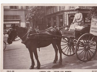 Photograph of a horse-drawn cart with a vendor of the publication ‘The Suffragette’