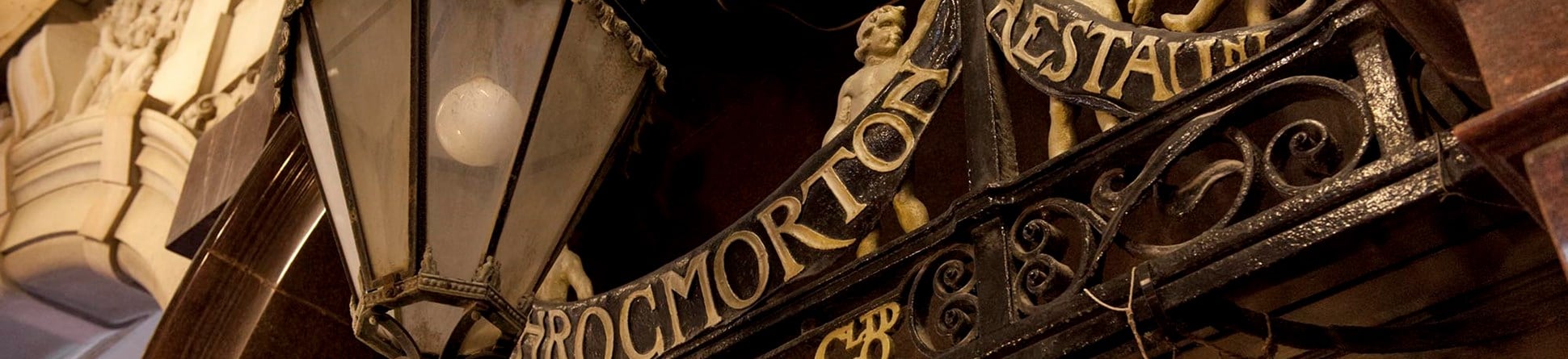 Detail of the signage for J Lyon's Throgmorton Restaurant and street lamp