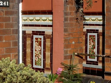 Alternating brick and tiled surfaces with garden plants in foreground.