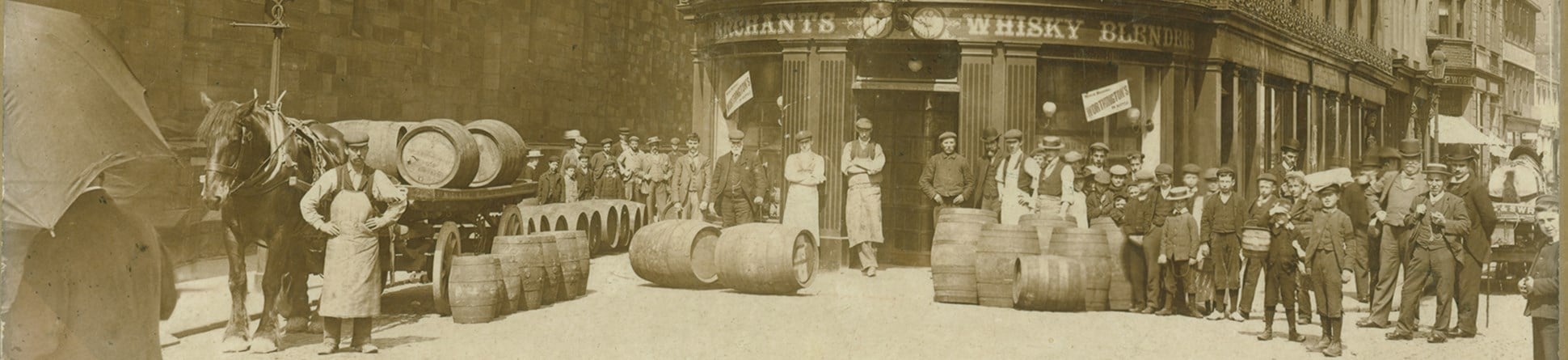 Exterior of the Spirit Vaults public house (later renamed Carlistle Arms) with a delivery of barrels being unloaded from a horse-drawn wagon.