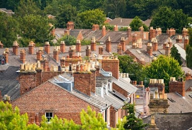 View across a sea of chimney pots and roof tops.
