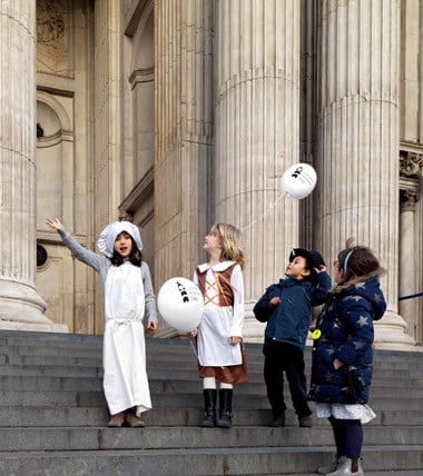 Children outside St Paul's Cathedral with London History Day balloons
