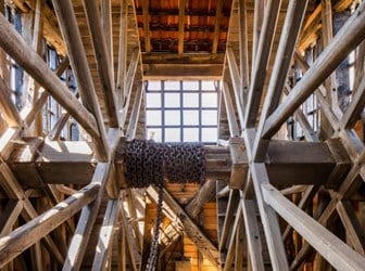 The interior of the Harwich Treadwheel Crane shows the two large wooden wheels with a heavy linked chain on the central shaft.