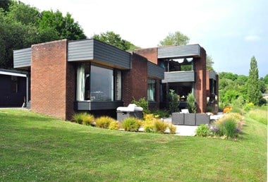 Modern brick house with large windows at various levels