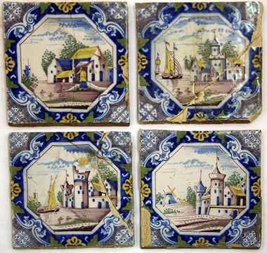 A collection of English Delft tiles from a fire surround. They show rural and waterside scenes in a square ‘picture-frame’ border of blue, purple, yellow and white. These date to the second half of the 18th century and were probably made in Liverpool.