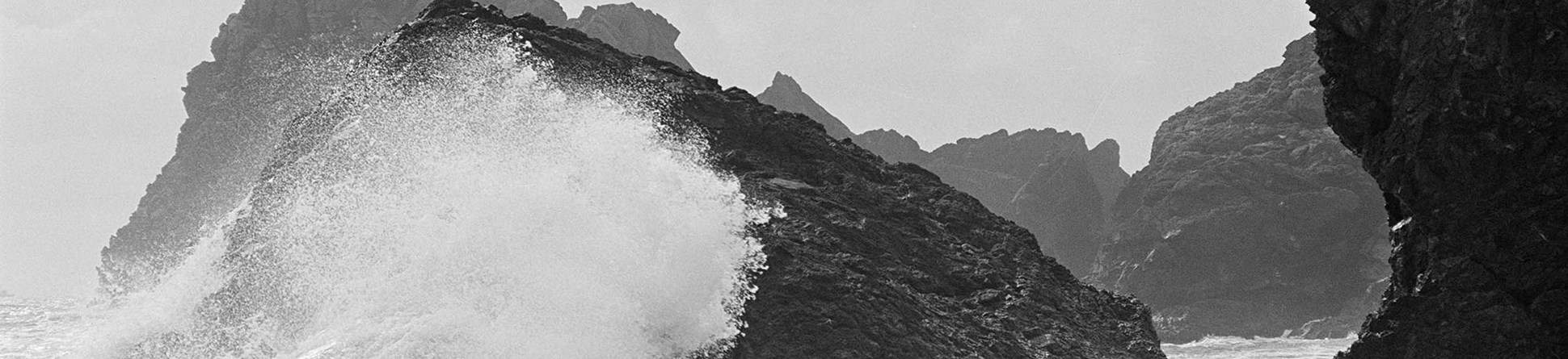 Waves crashing over rocky outcrops