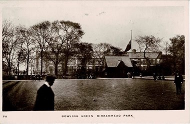 Black and white photo of people playing bowls.