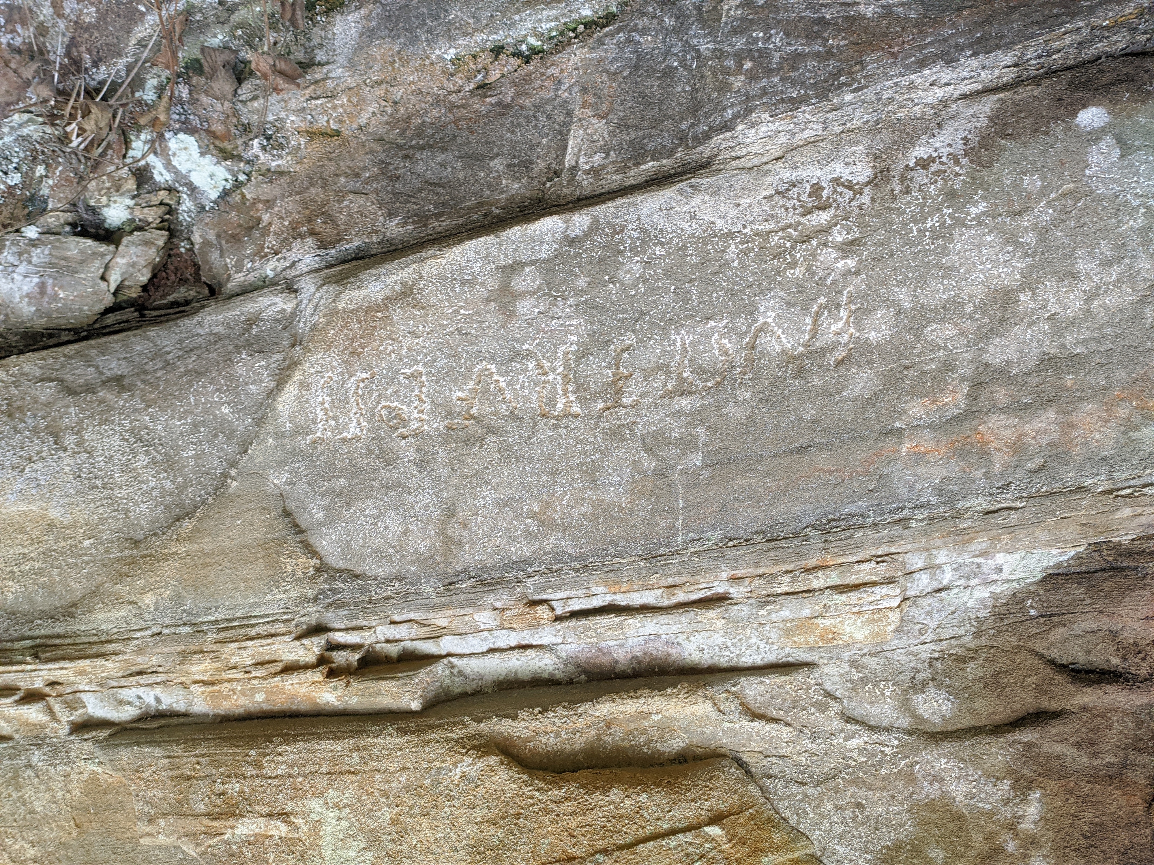 The first image corresponds to an inscription  found lower down and is likely the forgery.

