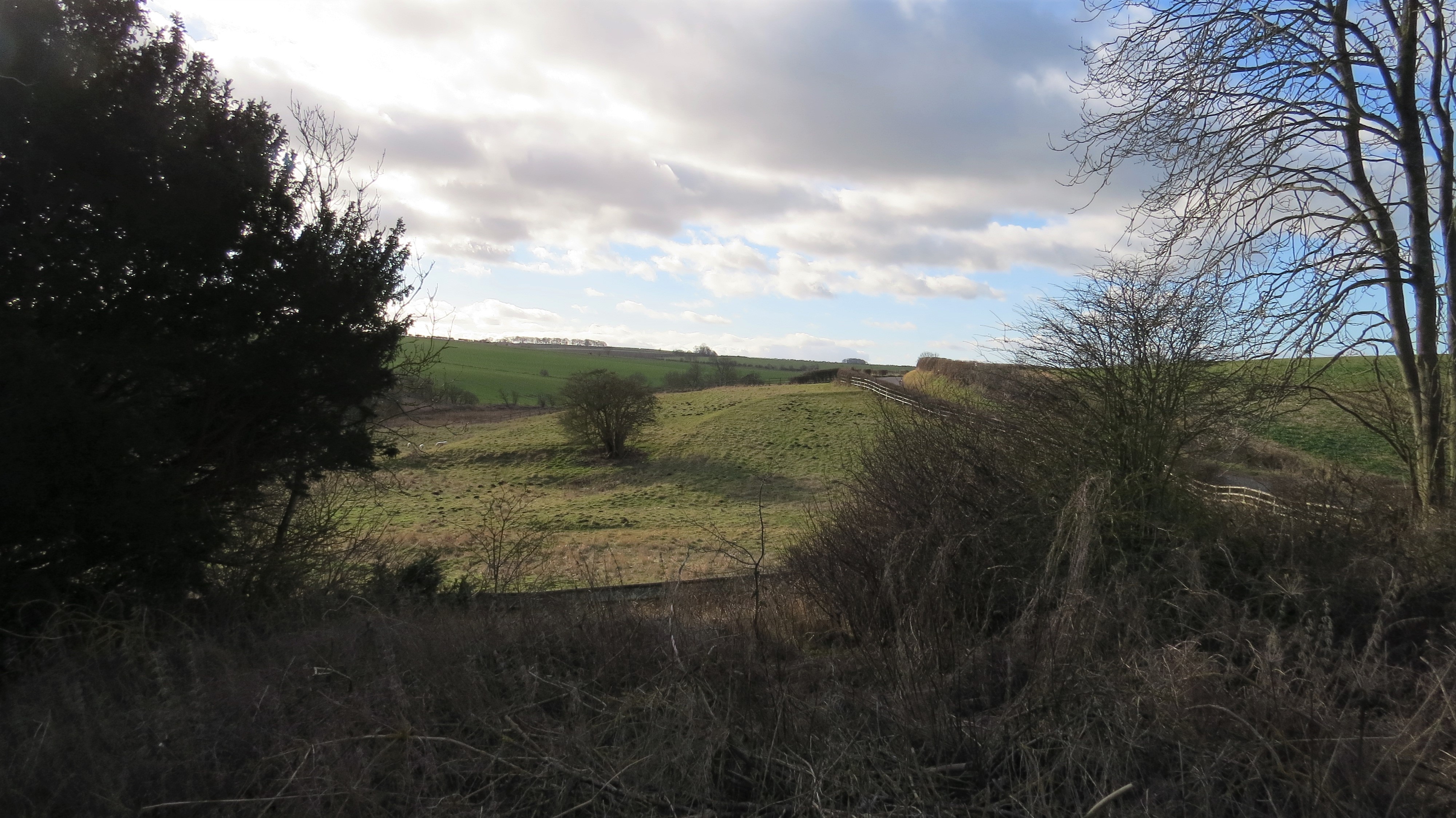 Kirby Grindalythe medieval settlement earthworks is pictured from the churchyard of  St Andrew's Church
