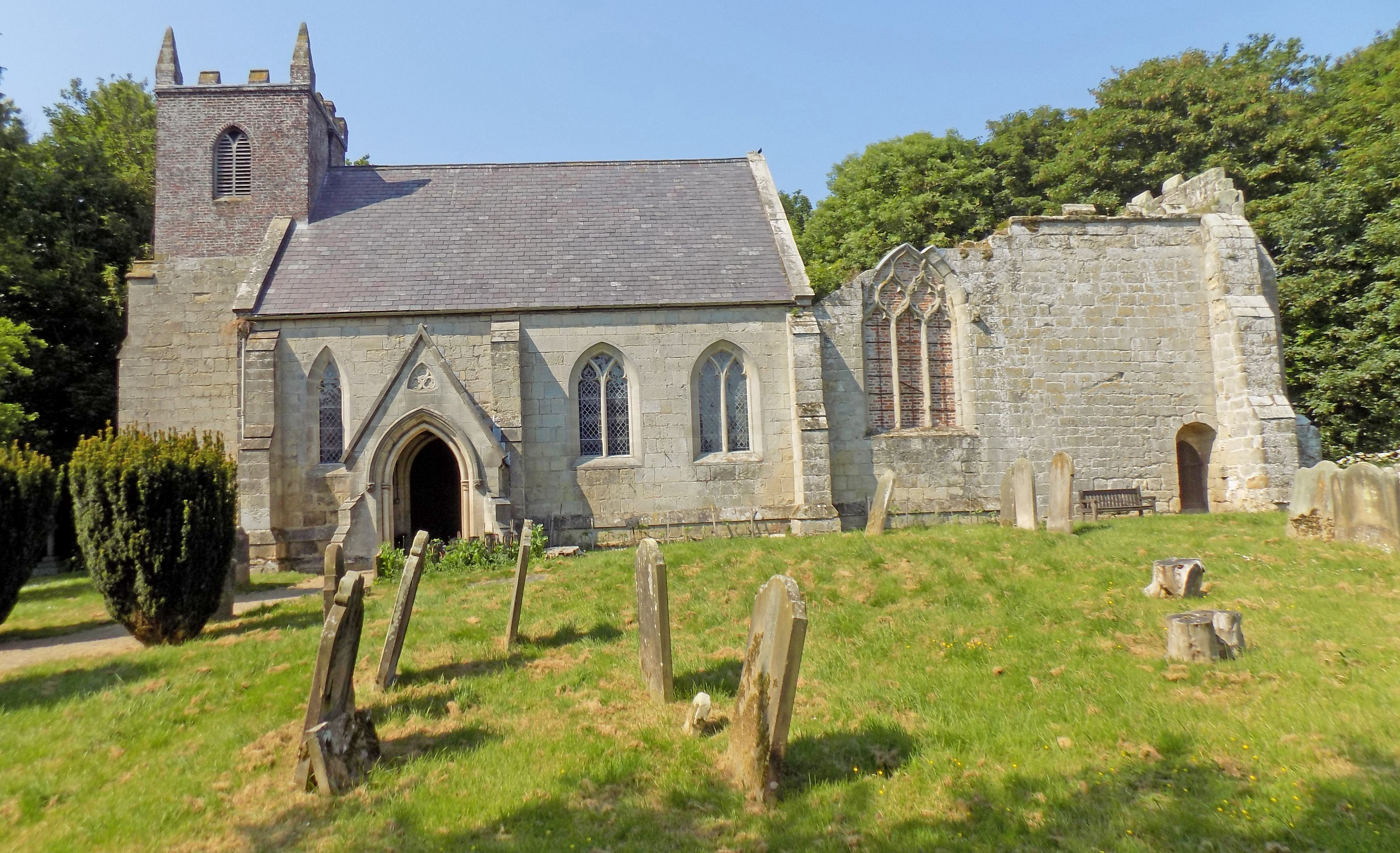 Rebuilt church with former ruined chancel still attached