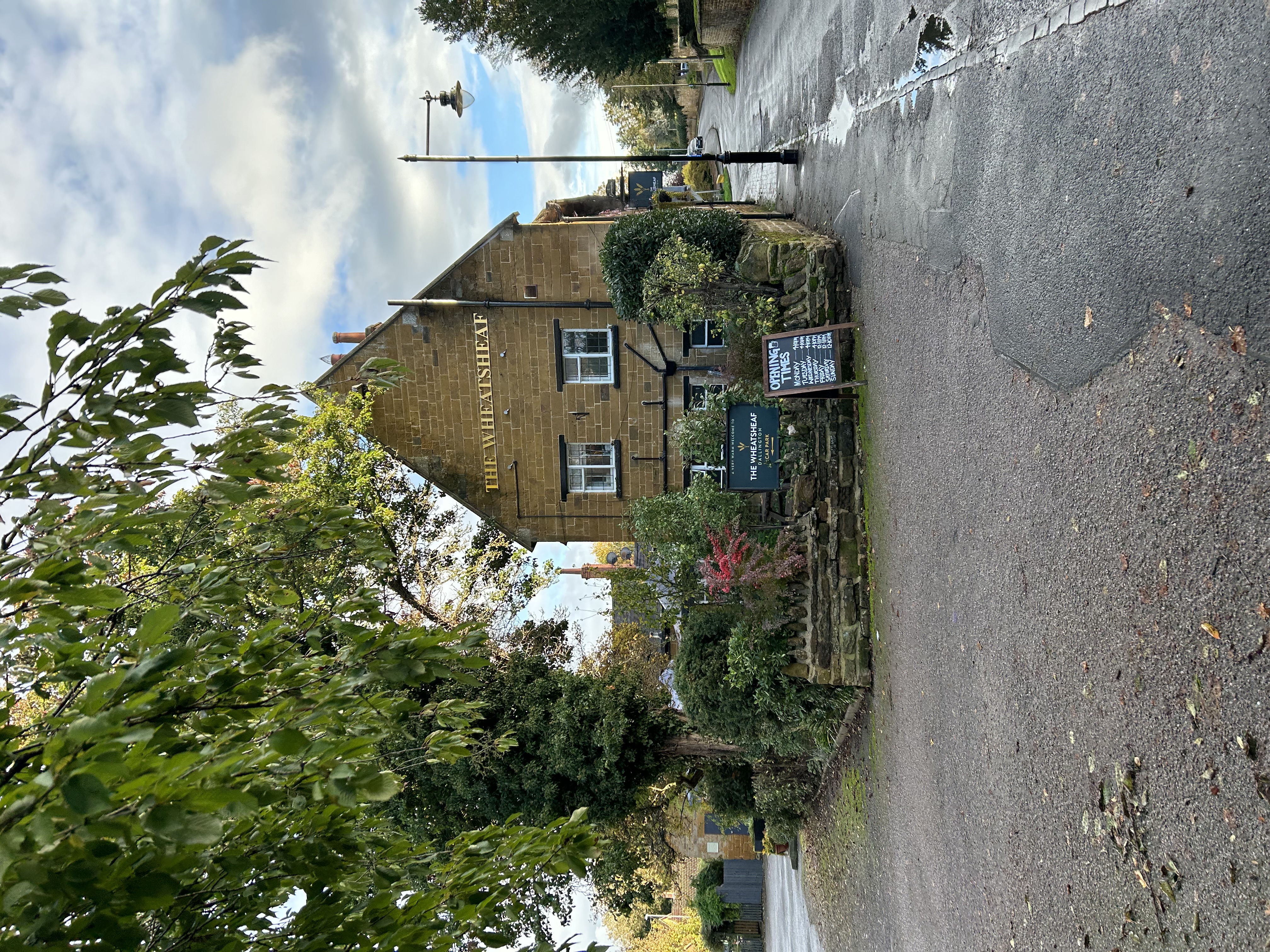 Photo of the side of The Wheatsheaf with gold signed lettering