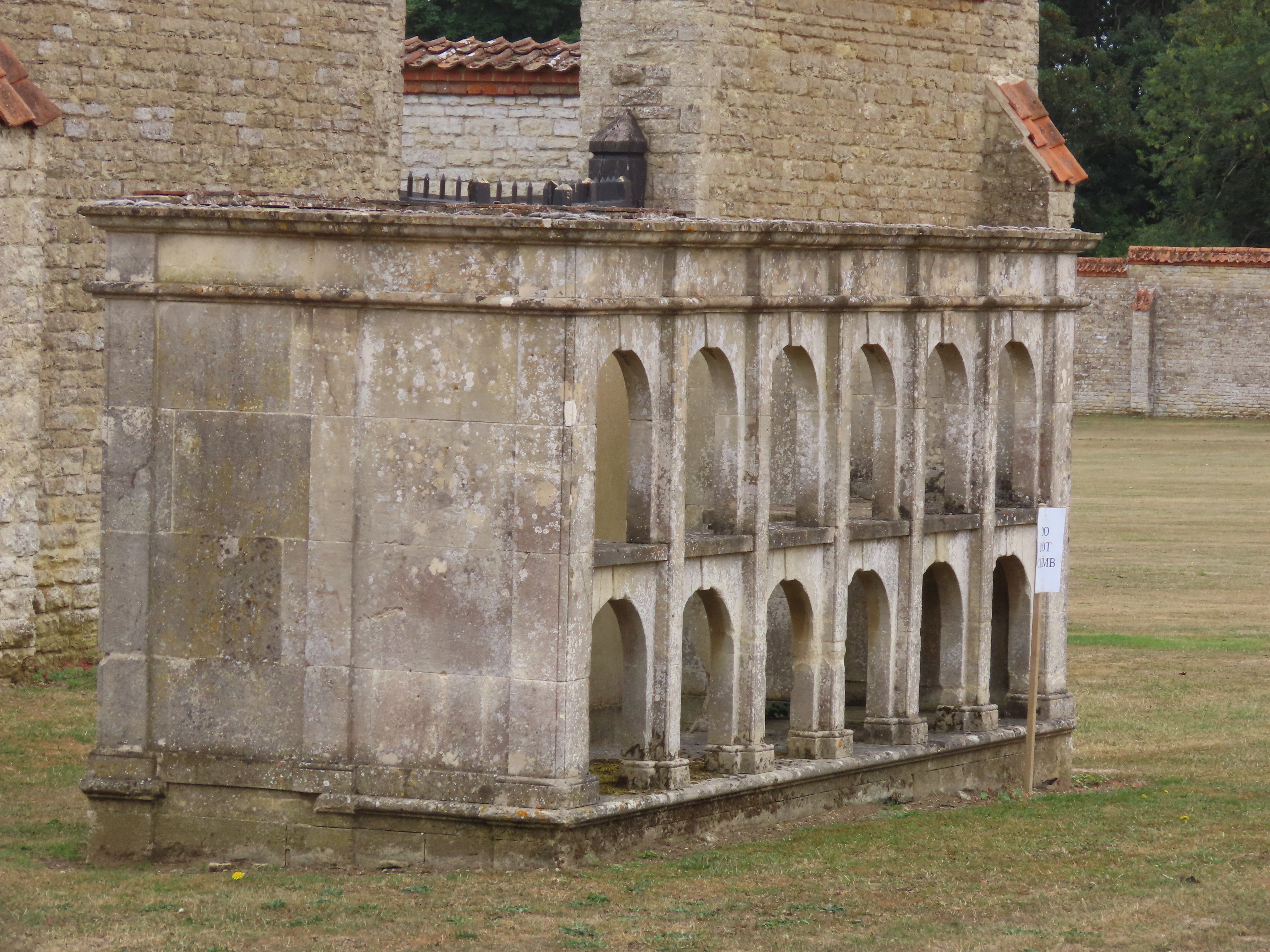 The Beehouse seen to the left in the Kitchen Garden or Walled Garden at Castle Ashby Gardens, seen through the gate.