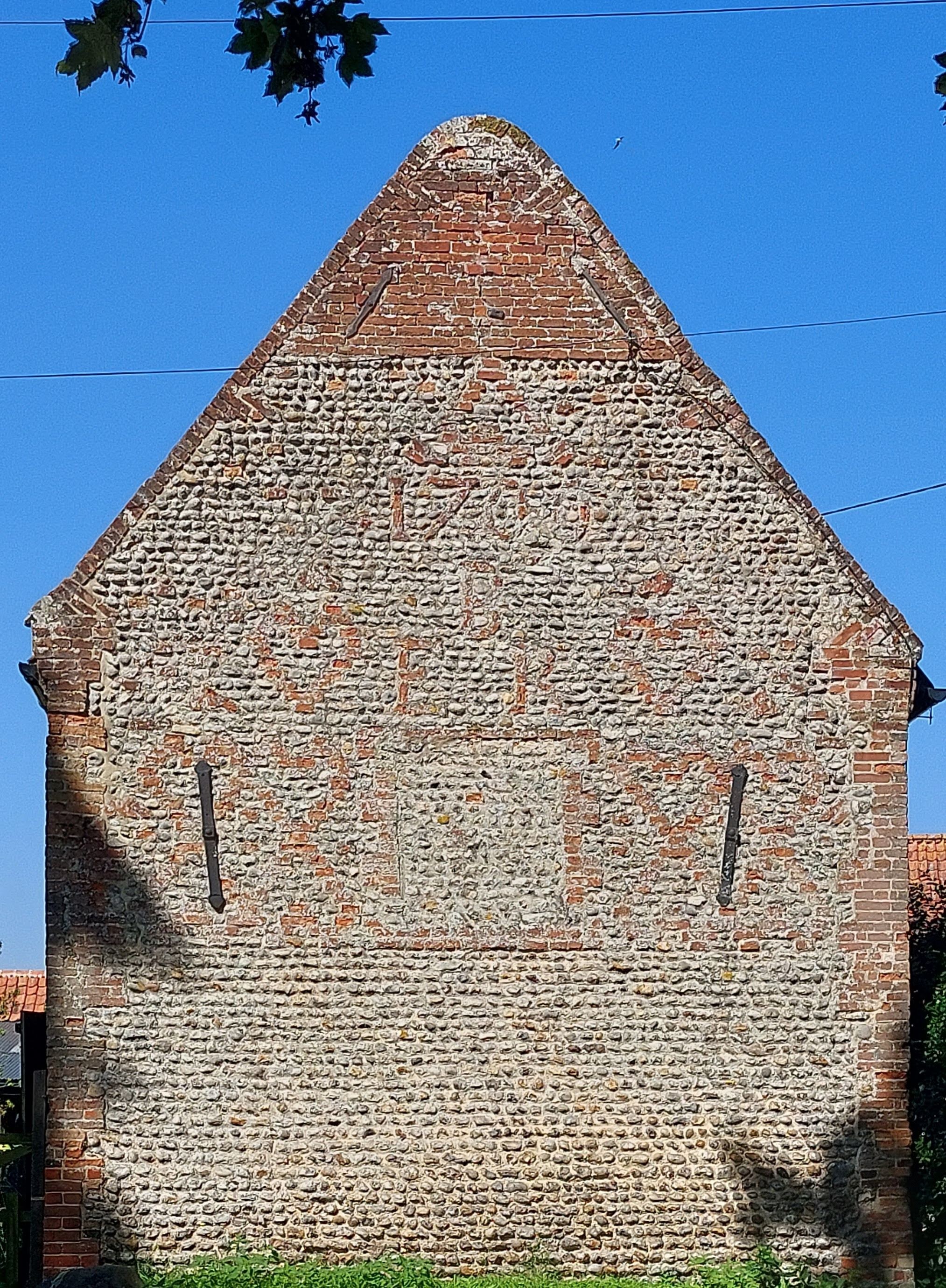 Side of a brick barn in Hunworth, Norfolk. Dated barn either 1700 or 1709. Decorated with red hearts and initials ER.