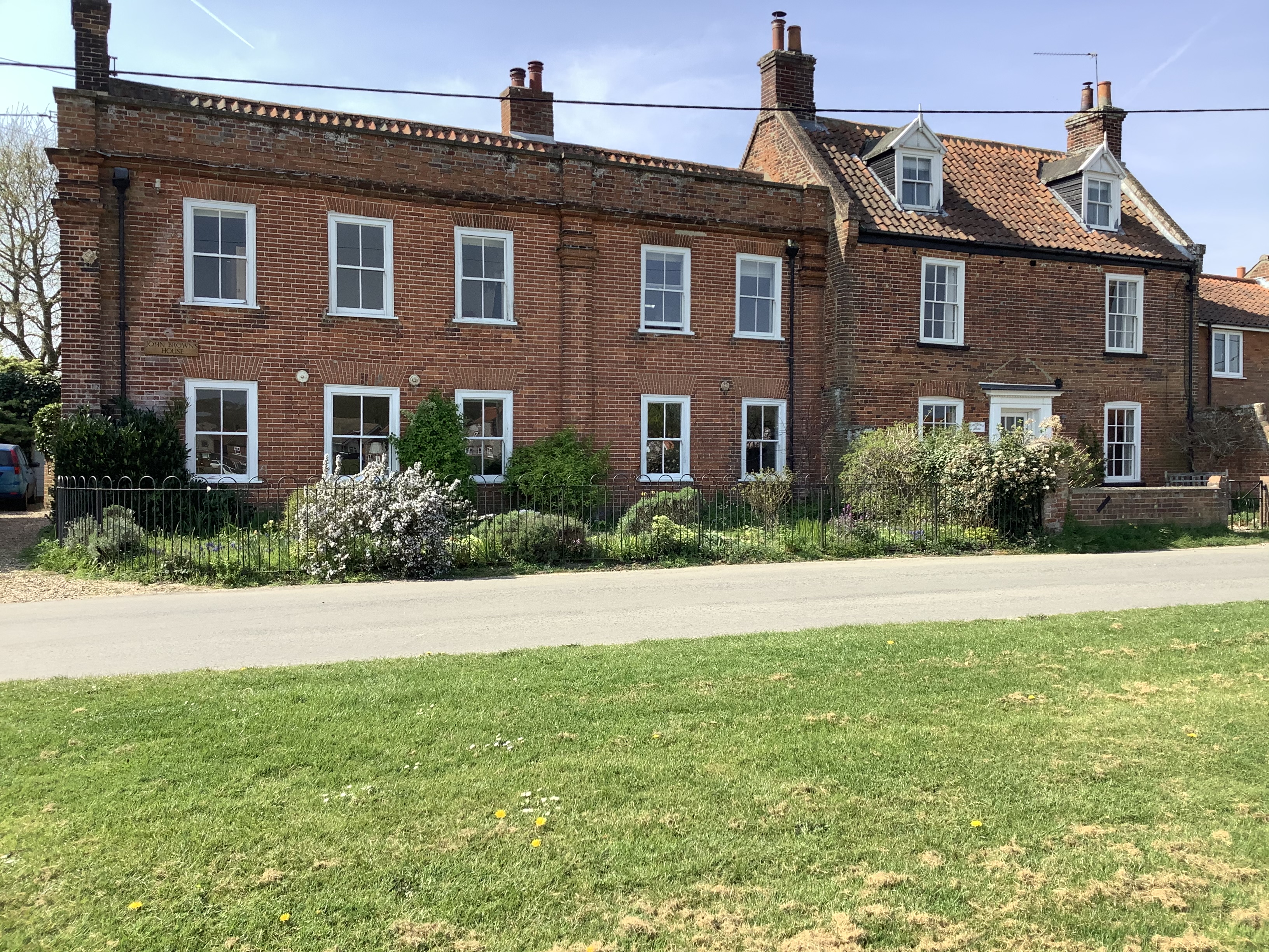 Early 18c. red brick. Double frontage but originally two cottages.