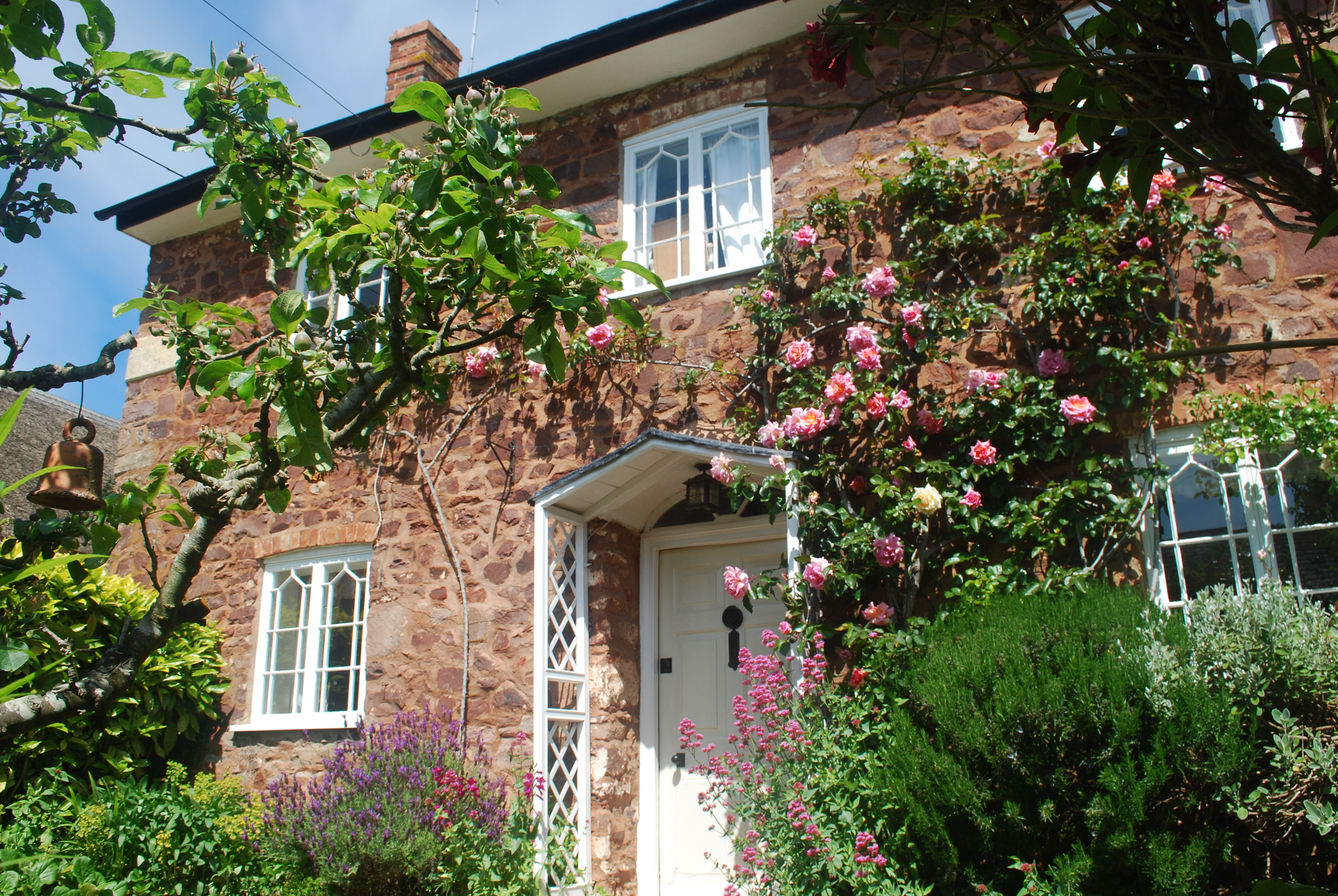 Vine Cottage (18 St. Georges Street) in summer showing front door and windows 