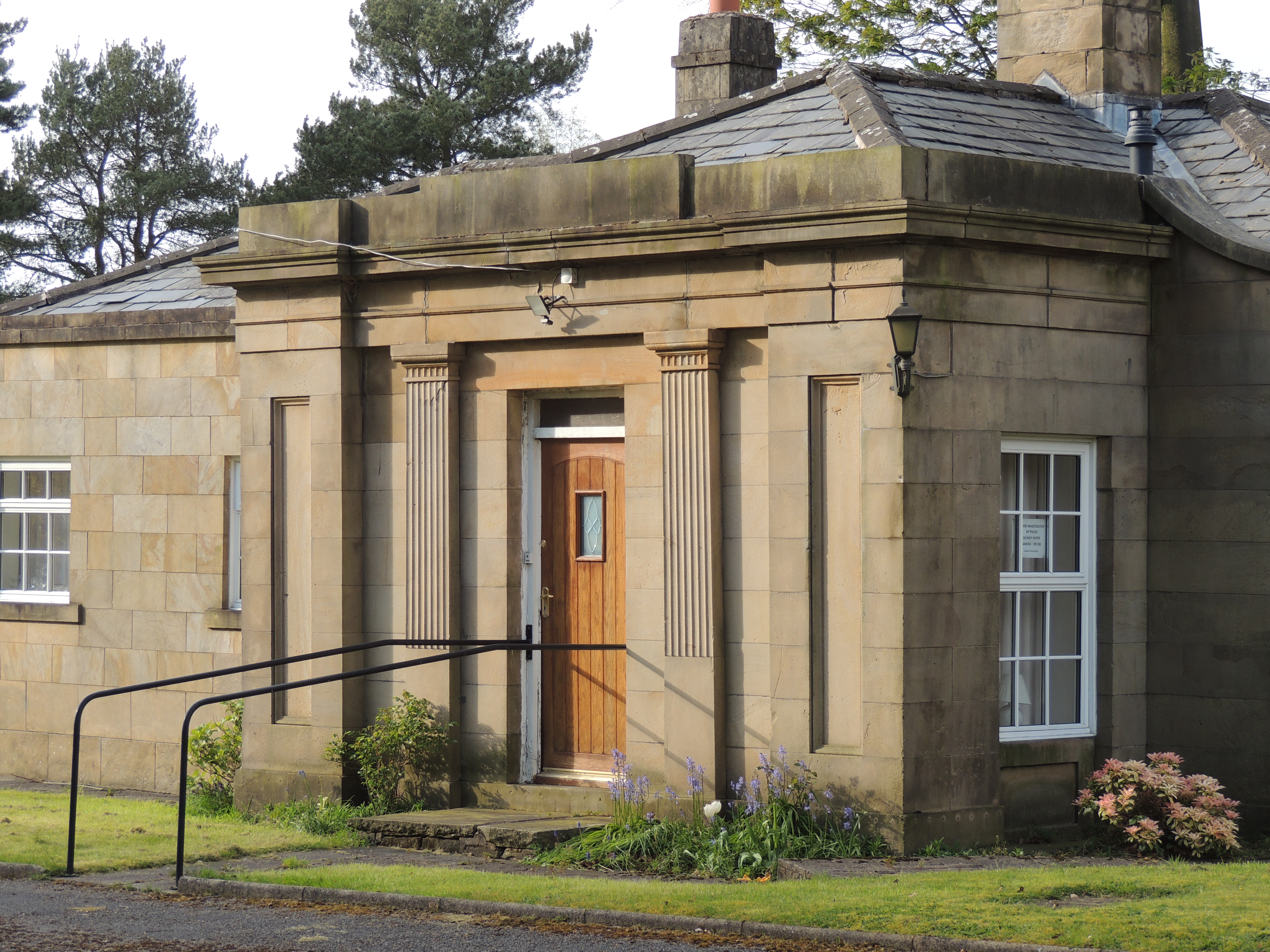 Wigan Lodge to Duxbury Park. Ashlar and rubble, low hipped slate roof with central chimney.  