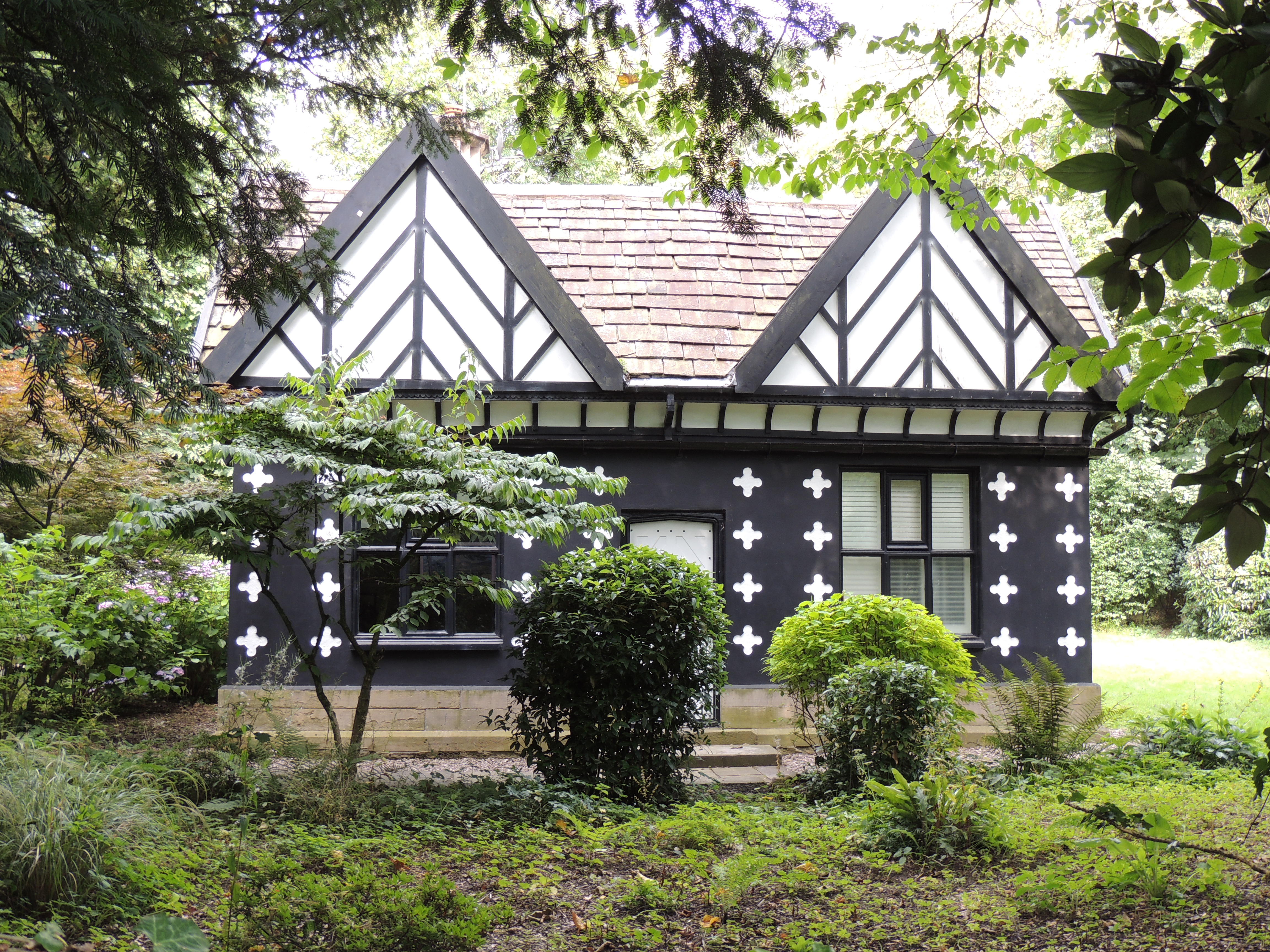 Lodge to Samlesbury Hall. Gate lodge, probably late 19th century. The inscription on north side of plinth is interesting
