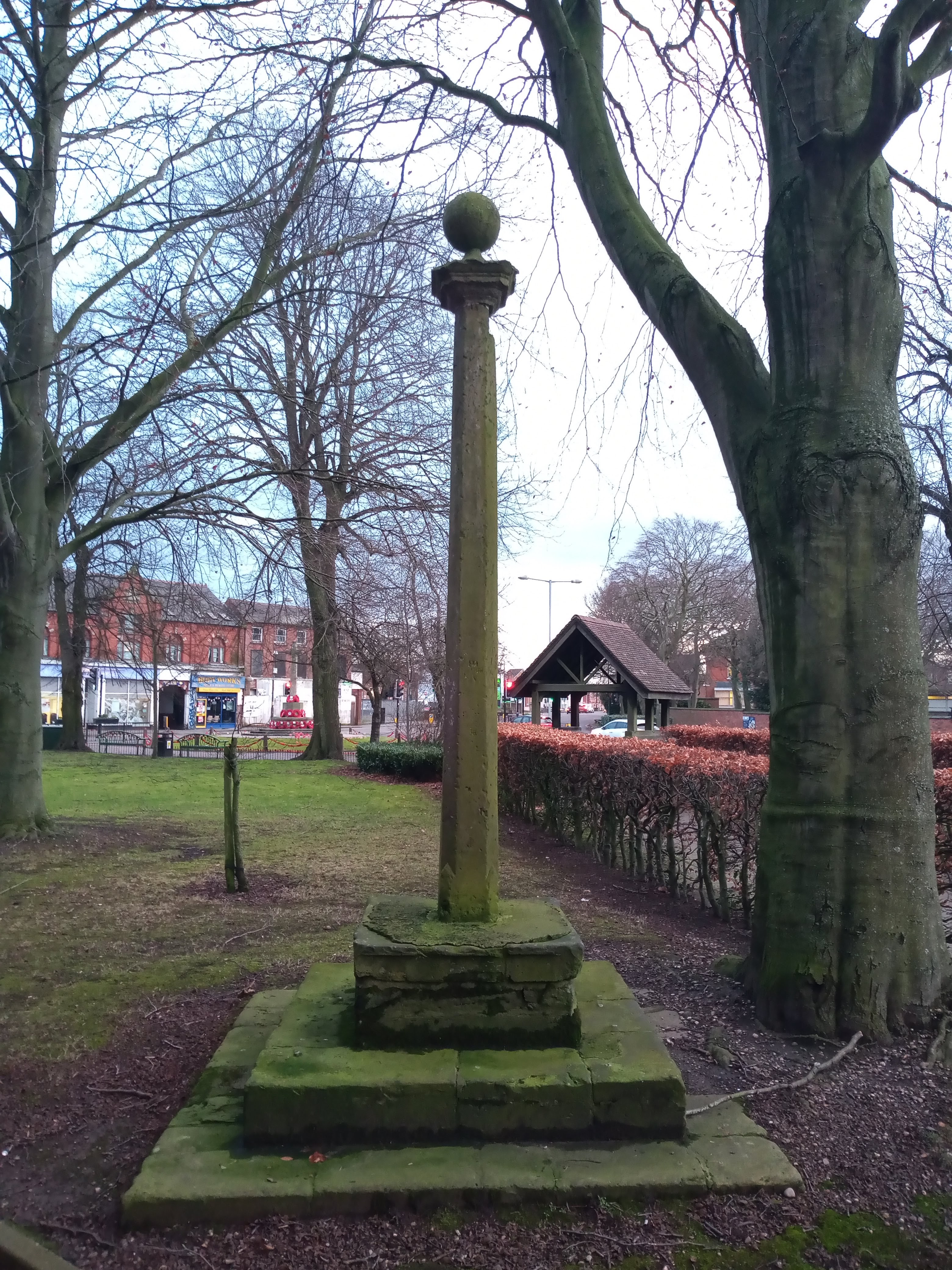 Green hued stone pillar - topped by a globe 