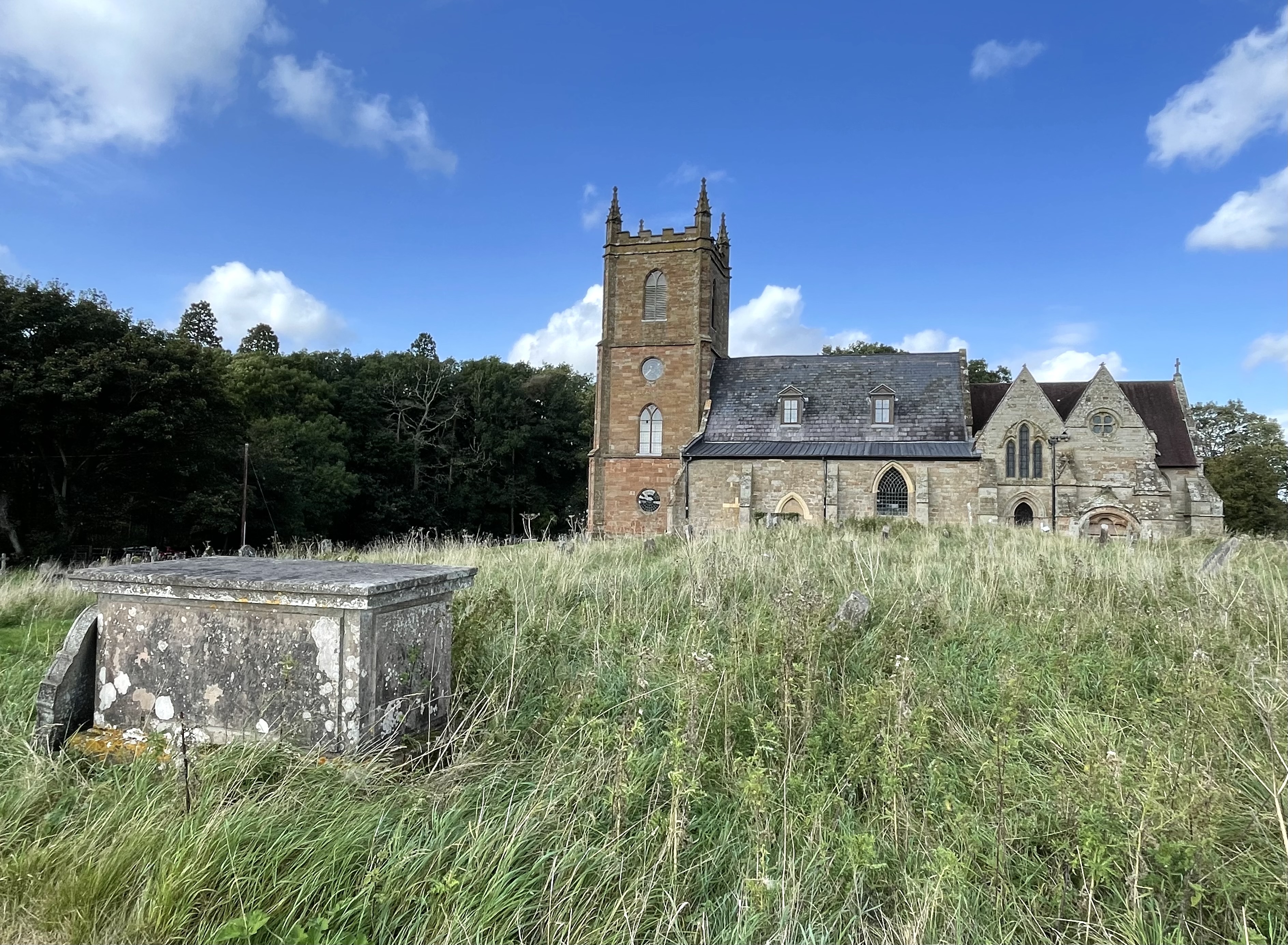 General view from south showing location in churchyard.