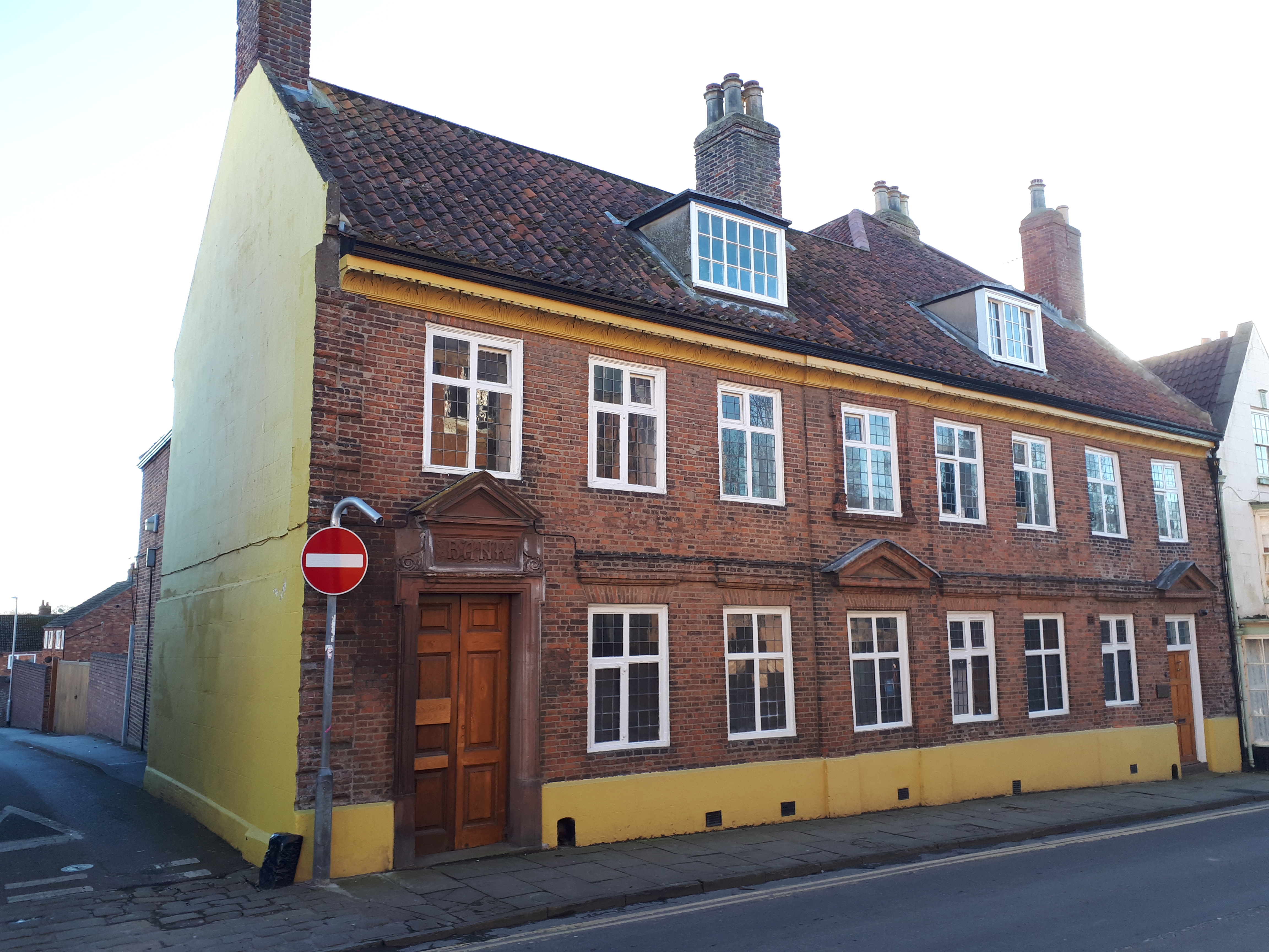 Front of Hebblethwaite House restored in 2021. The yellow is the original colour used on the carved acanthus cornice.