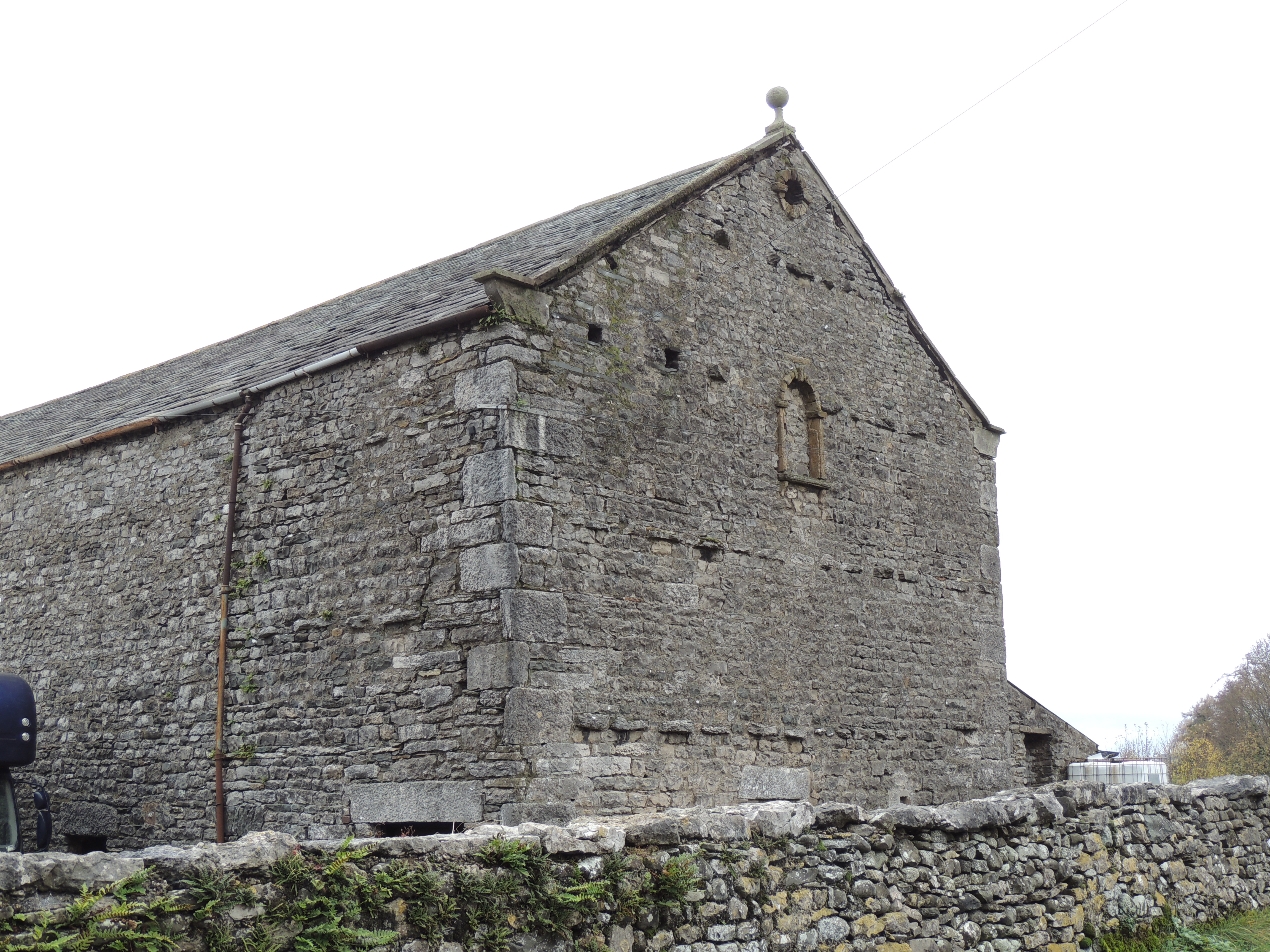 Bank barn, North of Farleton House, with threshing floor over shippons, probably from 18th century. 