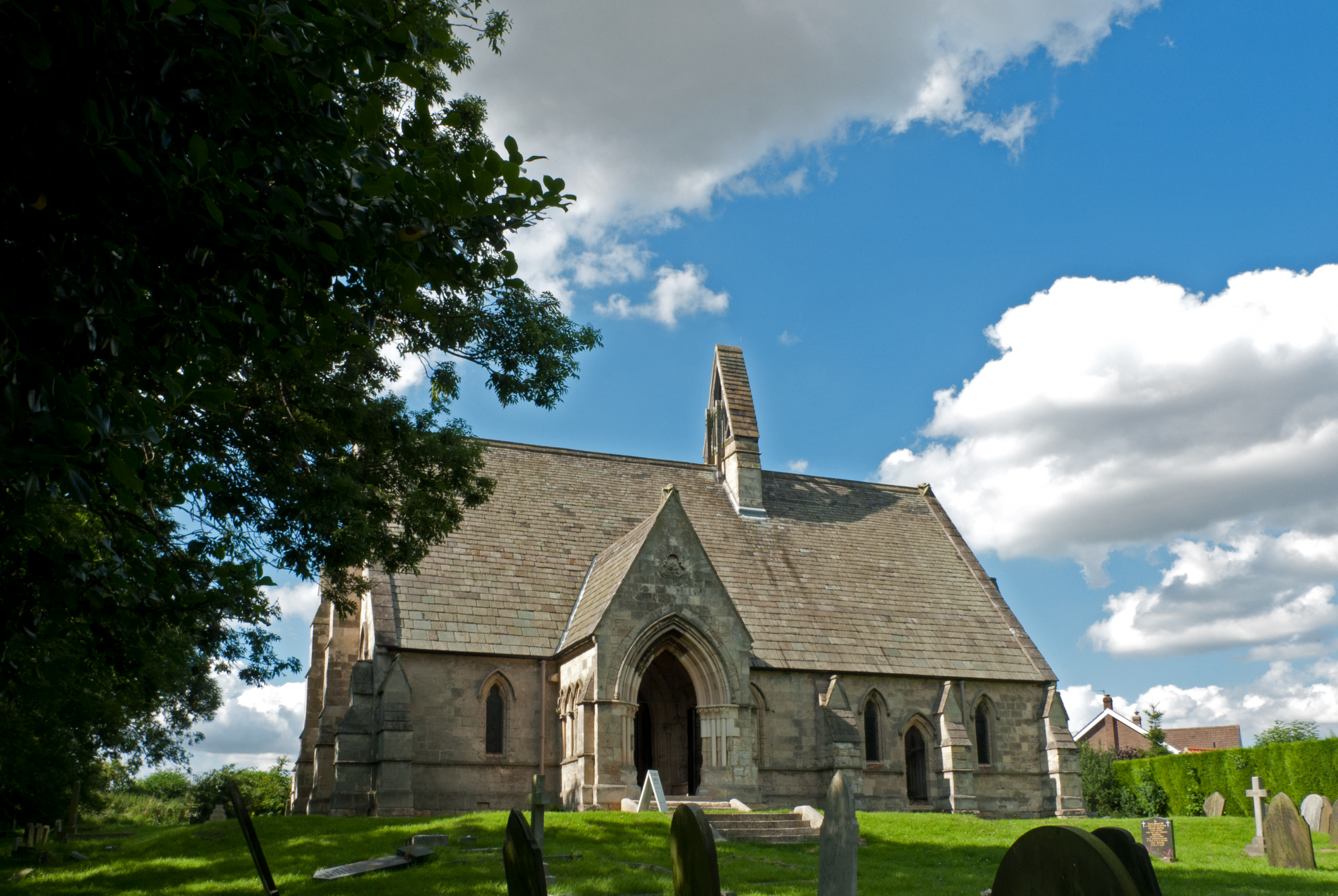 Exterior showing south porch and bell cote.