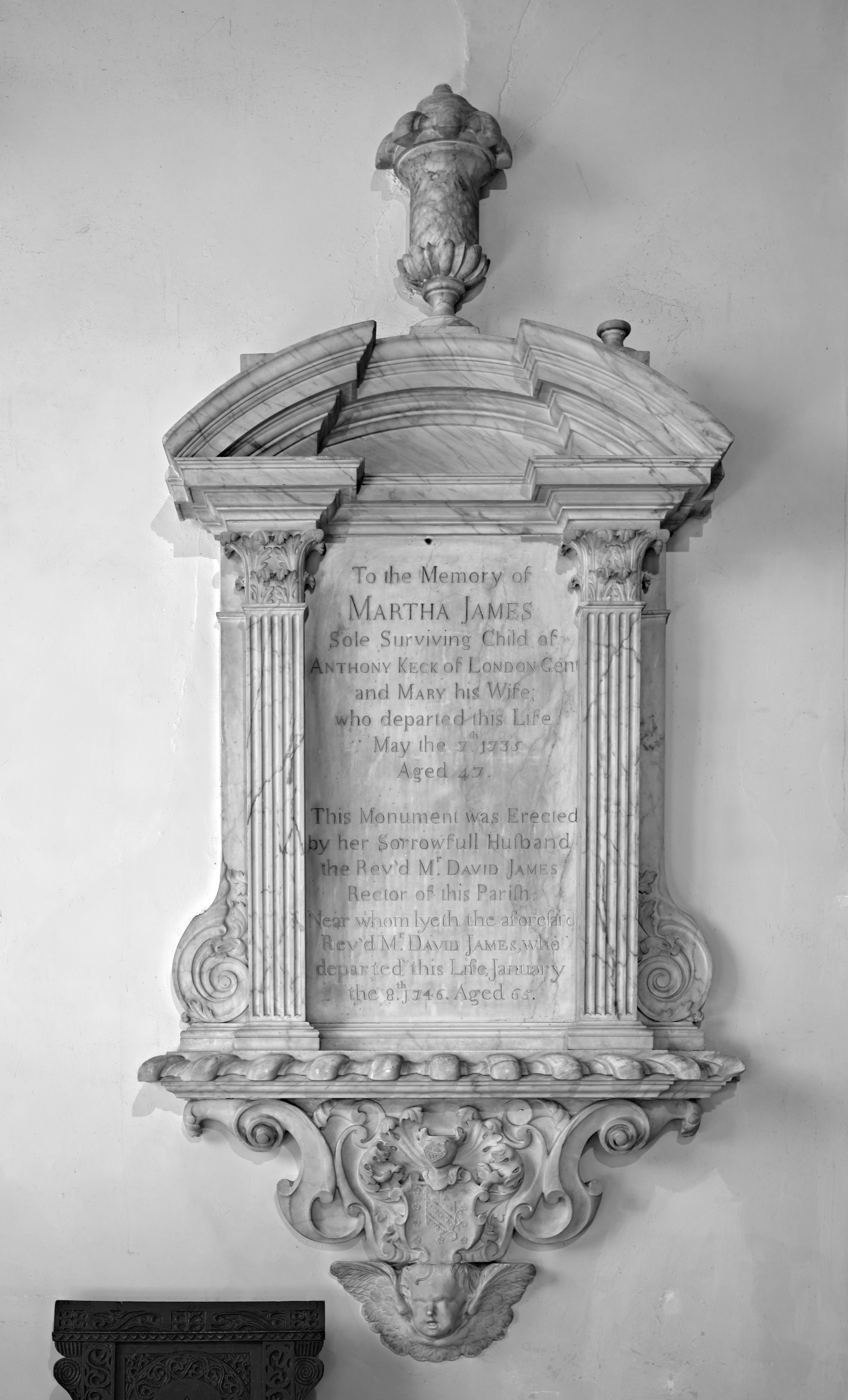Monument on S. chancel wall to Martha James 1746, a panel with flanking corinthian pilasters and side scrolls.