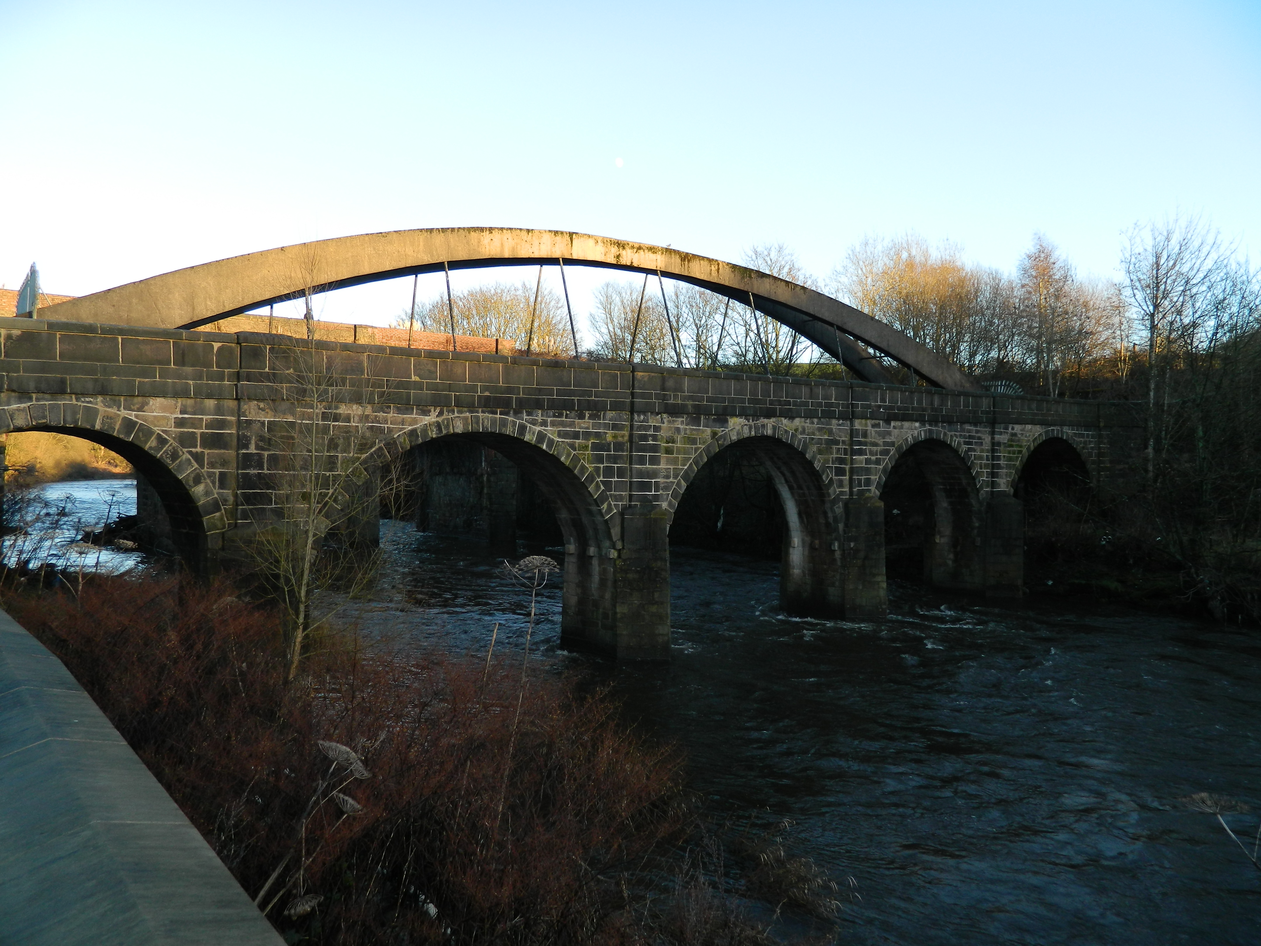 Prestolee Bridge over River Irwell. A packhorse bridge from the late 18th century, earlier than the adjacent aqueduct. 