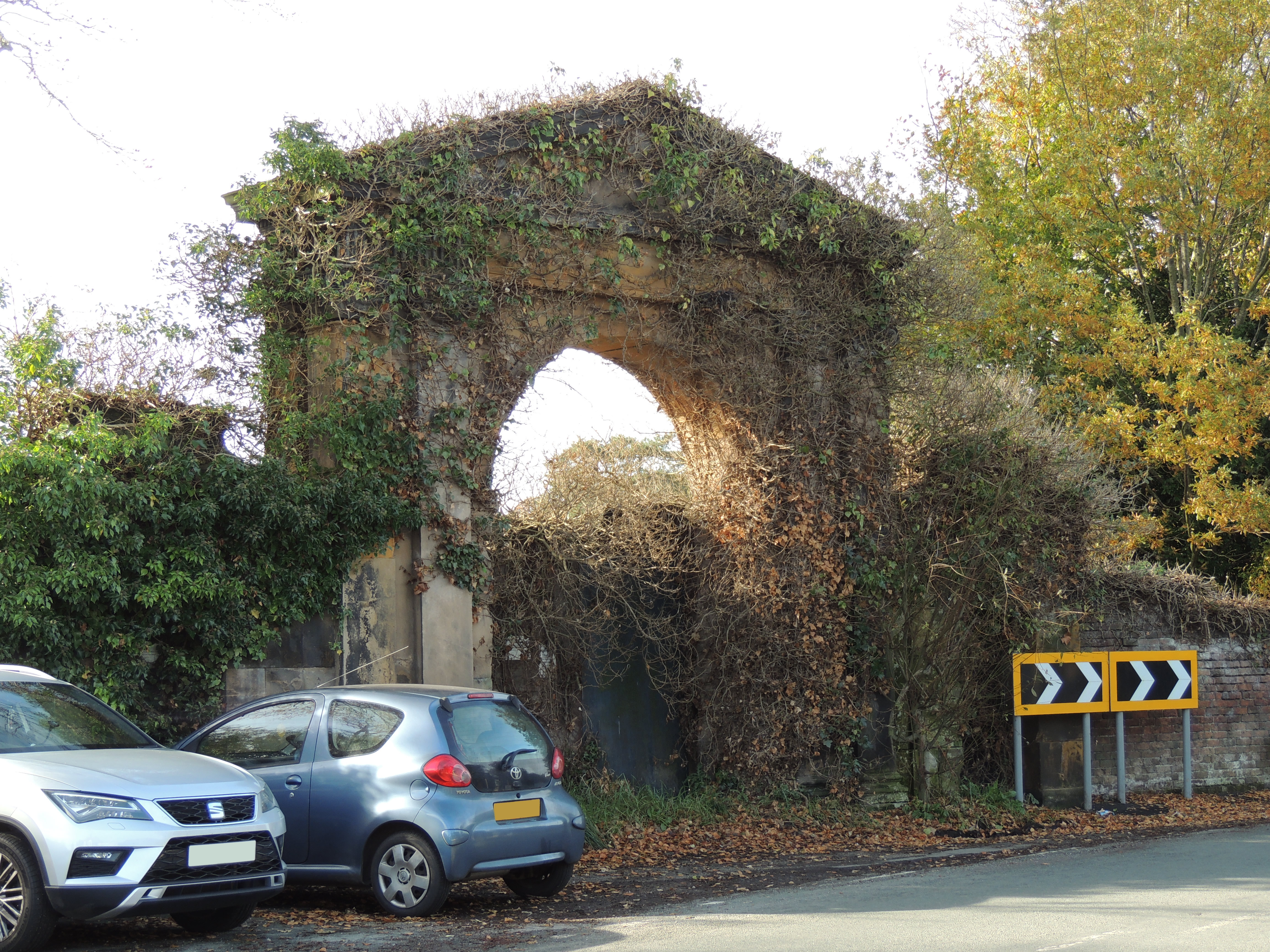 East gate to Ince Blundell Hall. Stone entrance archway and flanking pedestrian entrances, built  1770-1776.