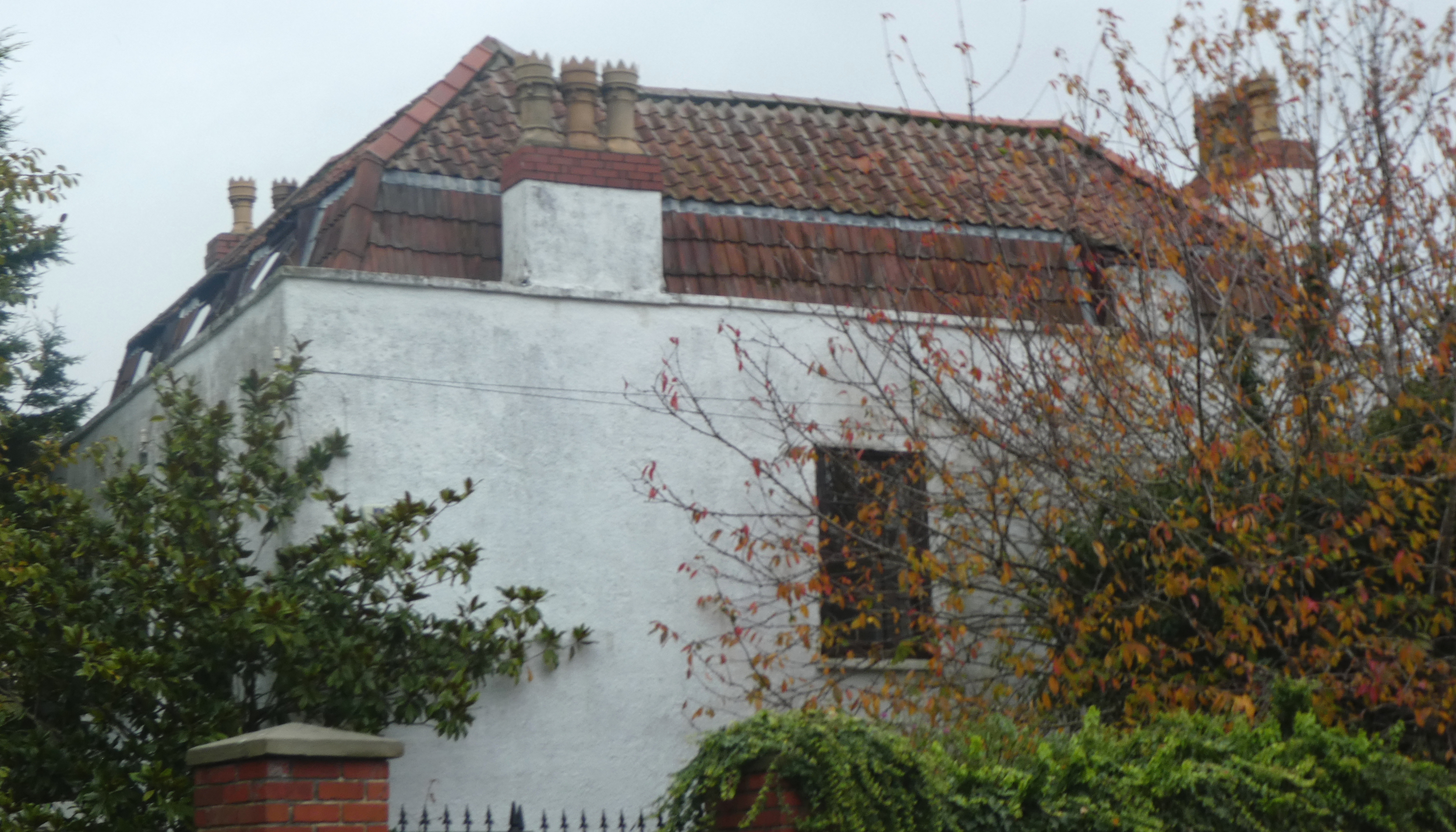 A partial view of the upper storey & roof