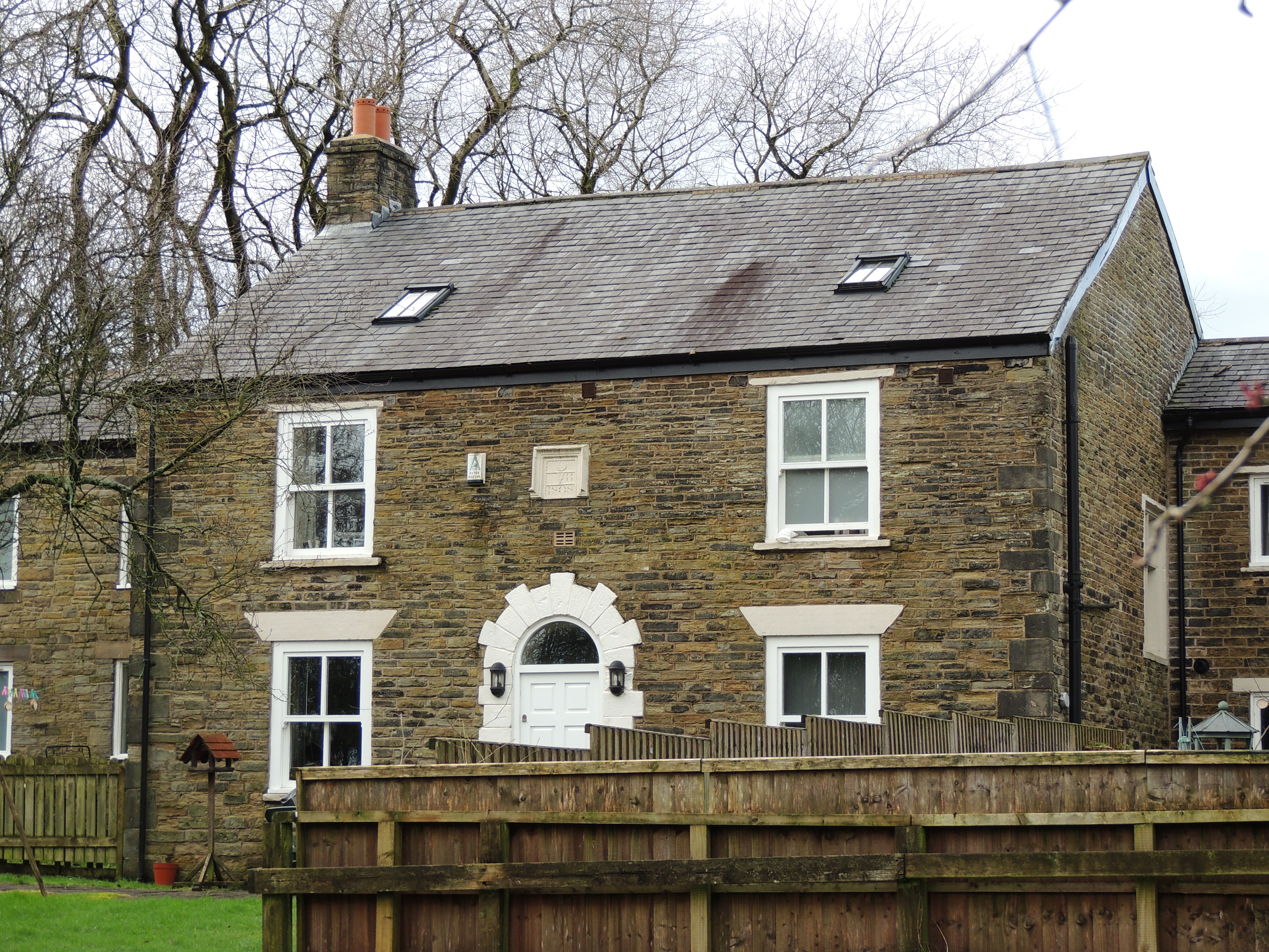 Knowles Farmhouse, Roby Mill. A farmhouse, dated 1808, at first floor, but probably a remodelling of an earlier house.