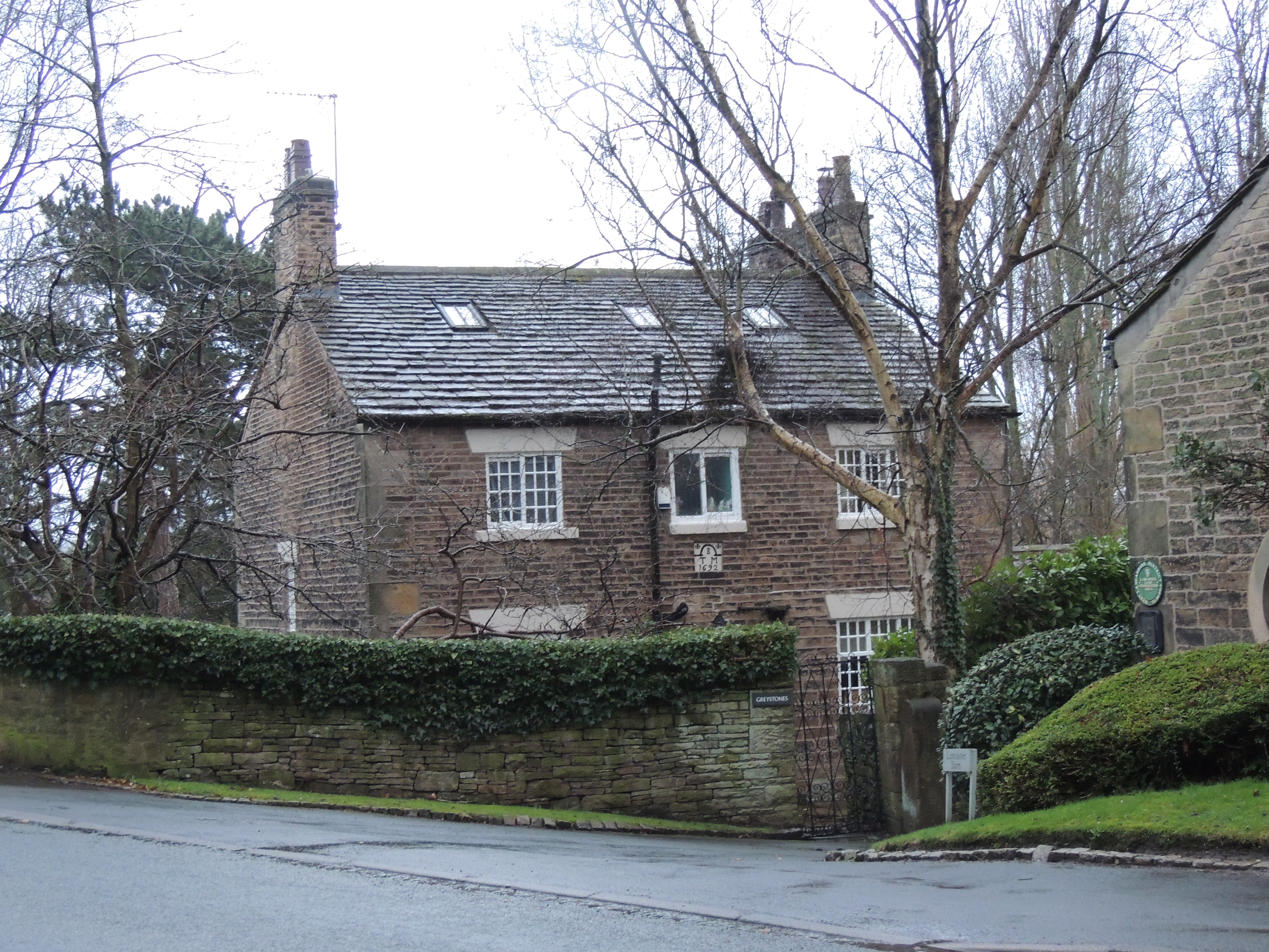 Greystones, Parbold, West Lancashire. A house built circa 1800 with re-set plaque, inscribed 'TBM 1692', above the door.
