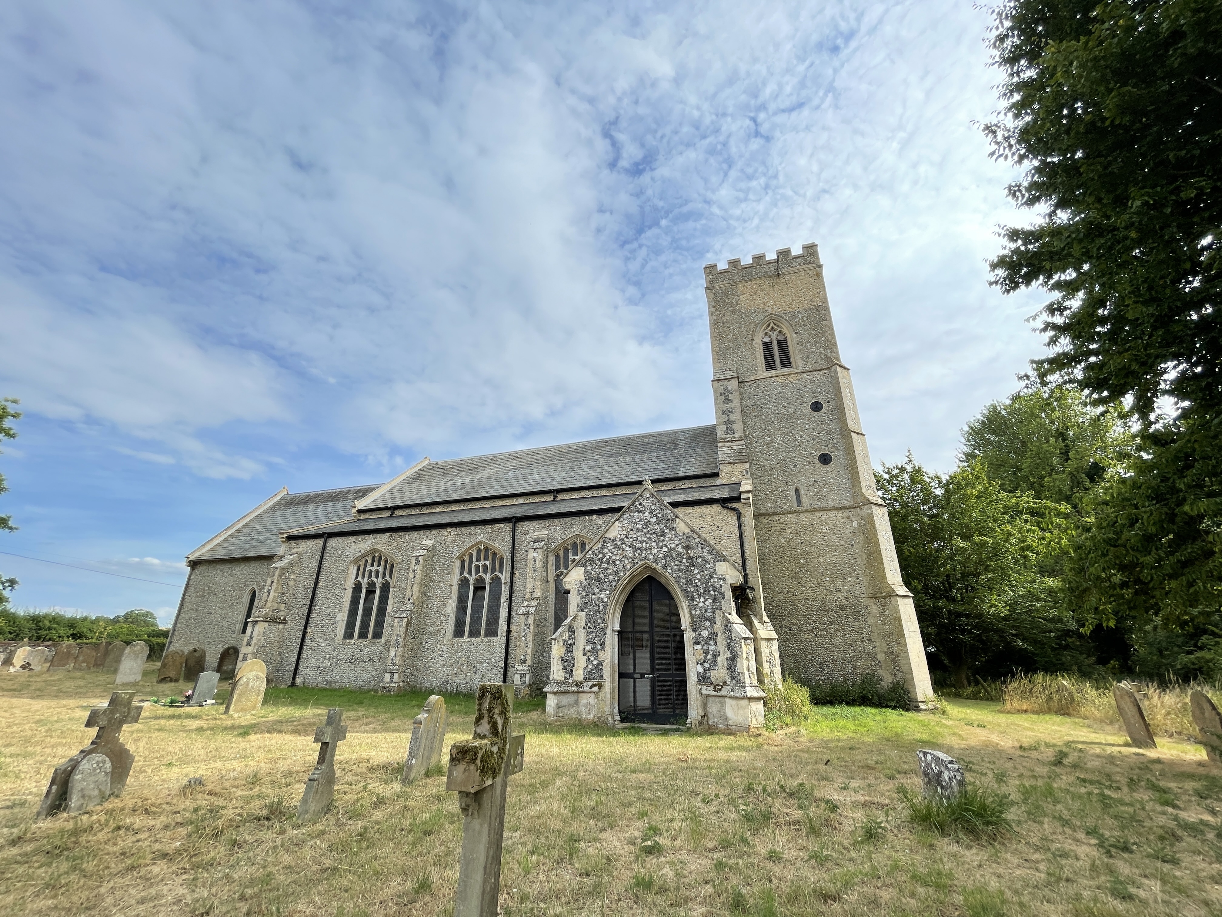 Snetterton All Saints from the north west, showing 14th century tower and 15th century north porch