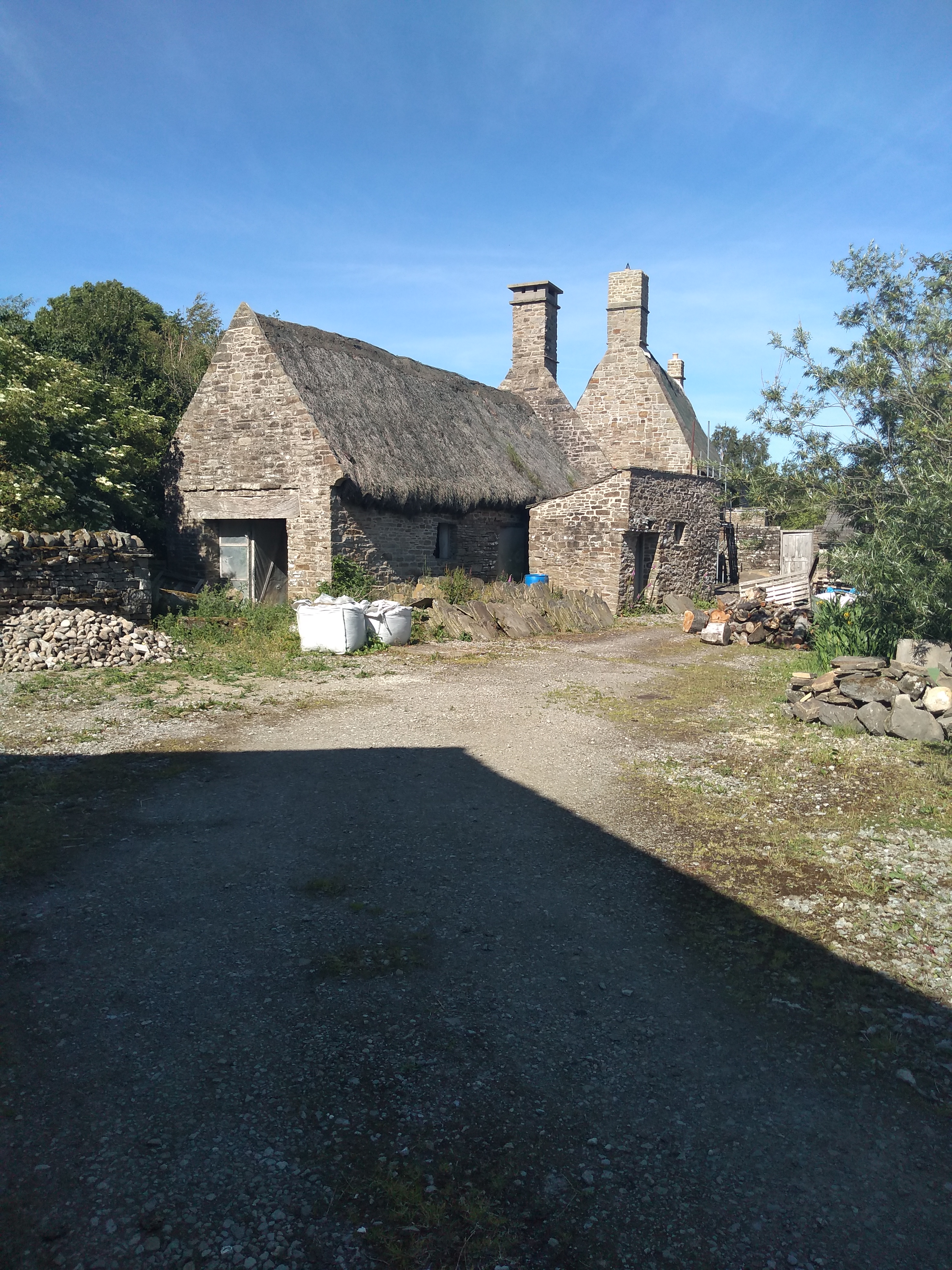 Two thatched houses in a beautiful and remote area in their own enclosed space. Acres of blue sky.