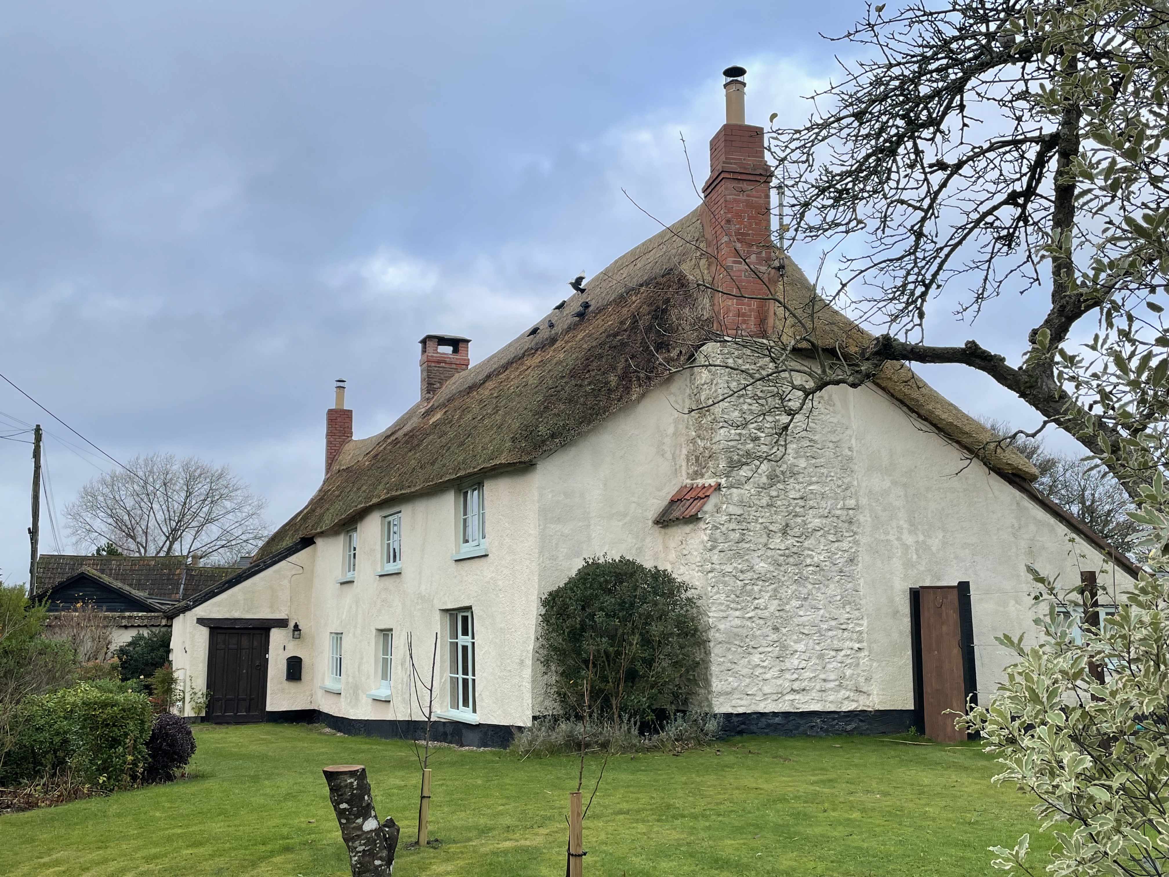 Large thatched house with 3 chimneys