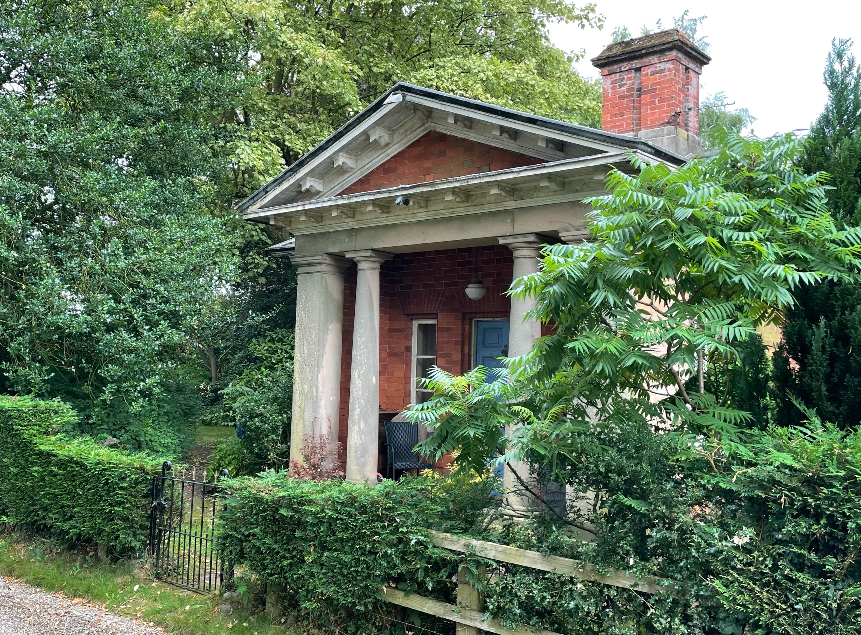 View from East showing Tuscan porch and chimney.