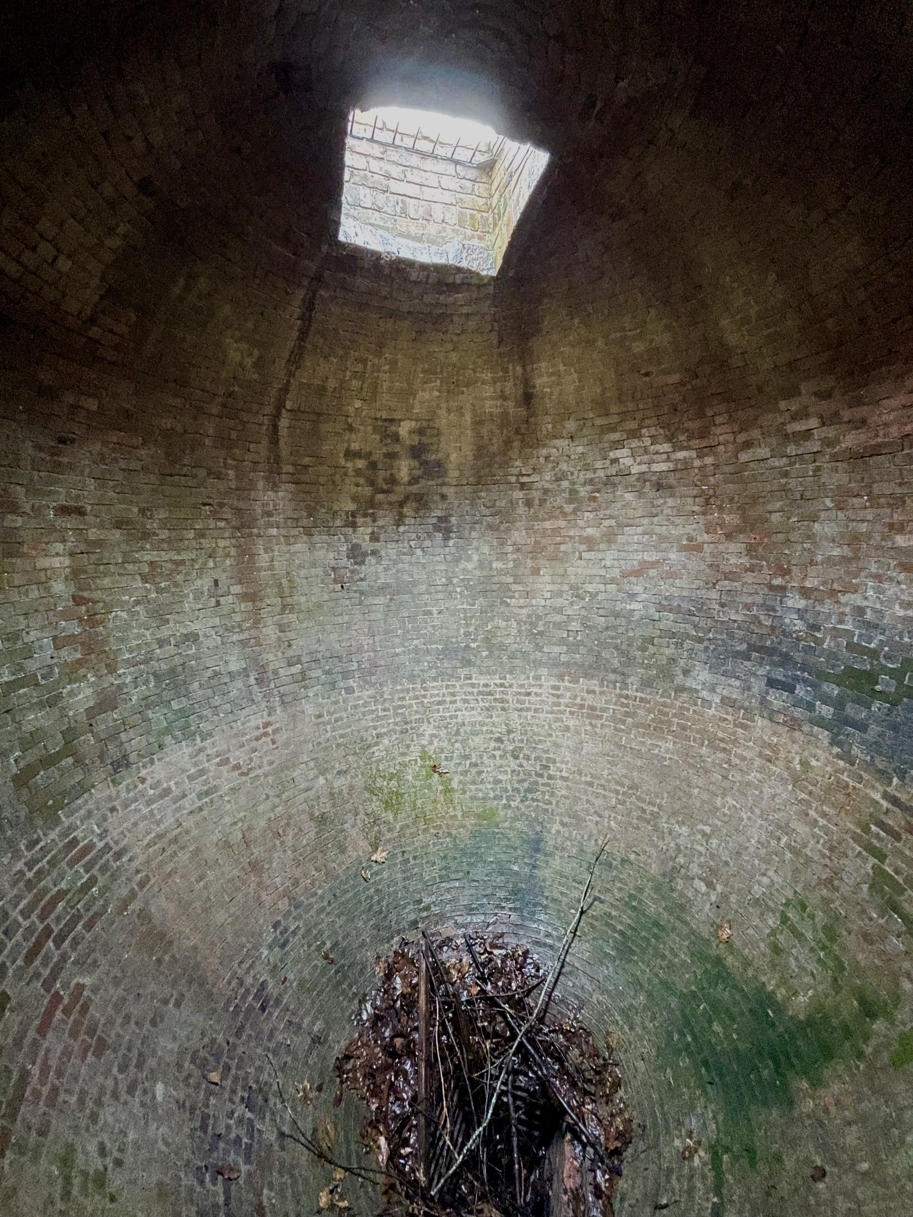 Internal view of ice house showing loading hatch to top and drain to bottom.