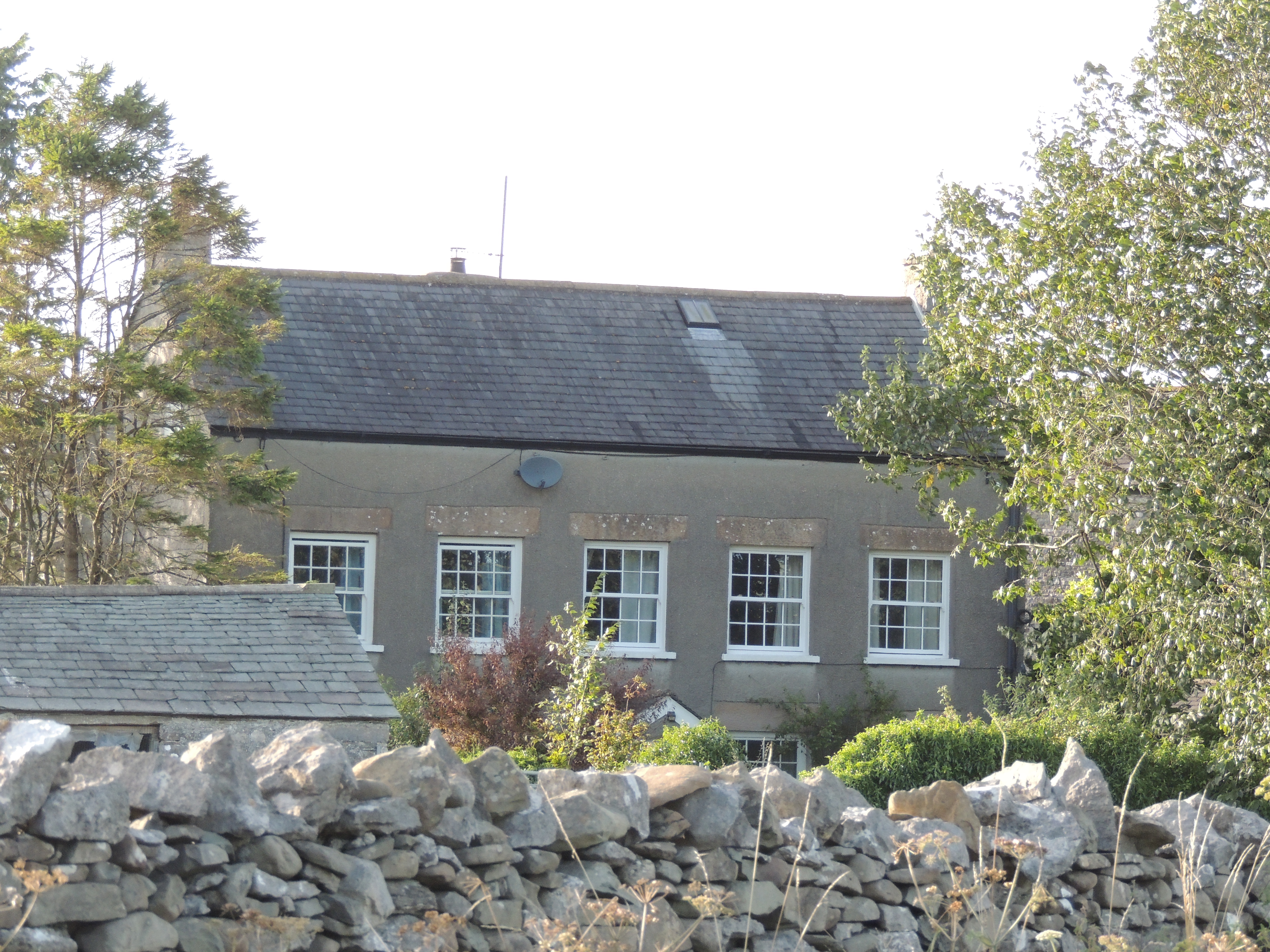 Moss End Farmhouse, probably from the early 18th century, remodelled and extended to rear the in the early 19th century.
