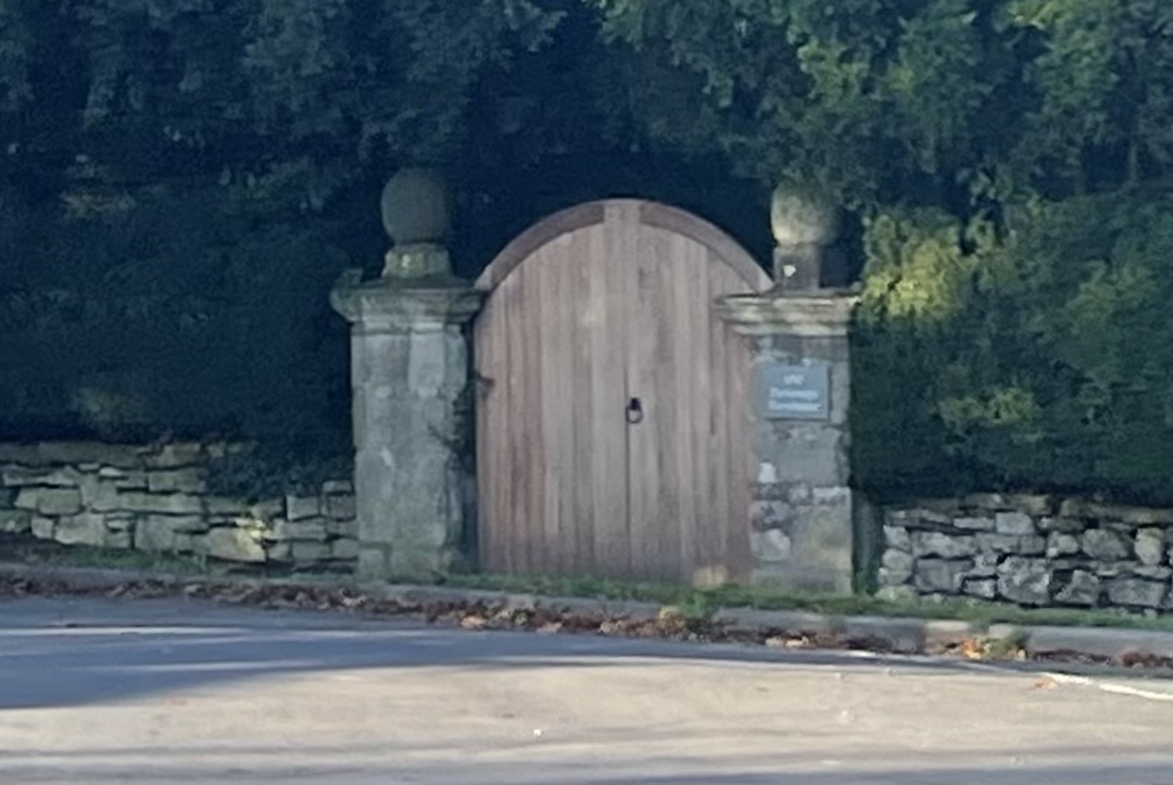 Gate piers from east, showing corniced caps and ball finials.