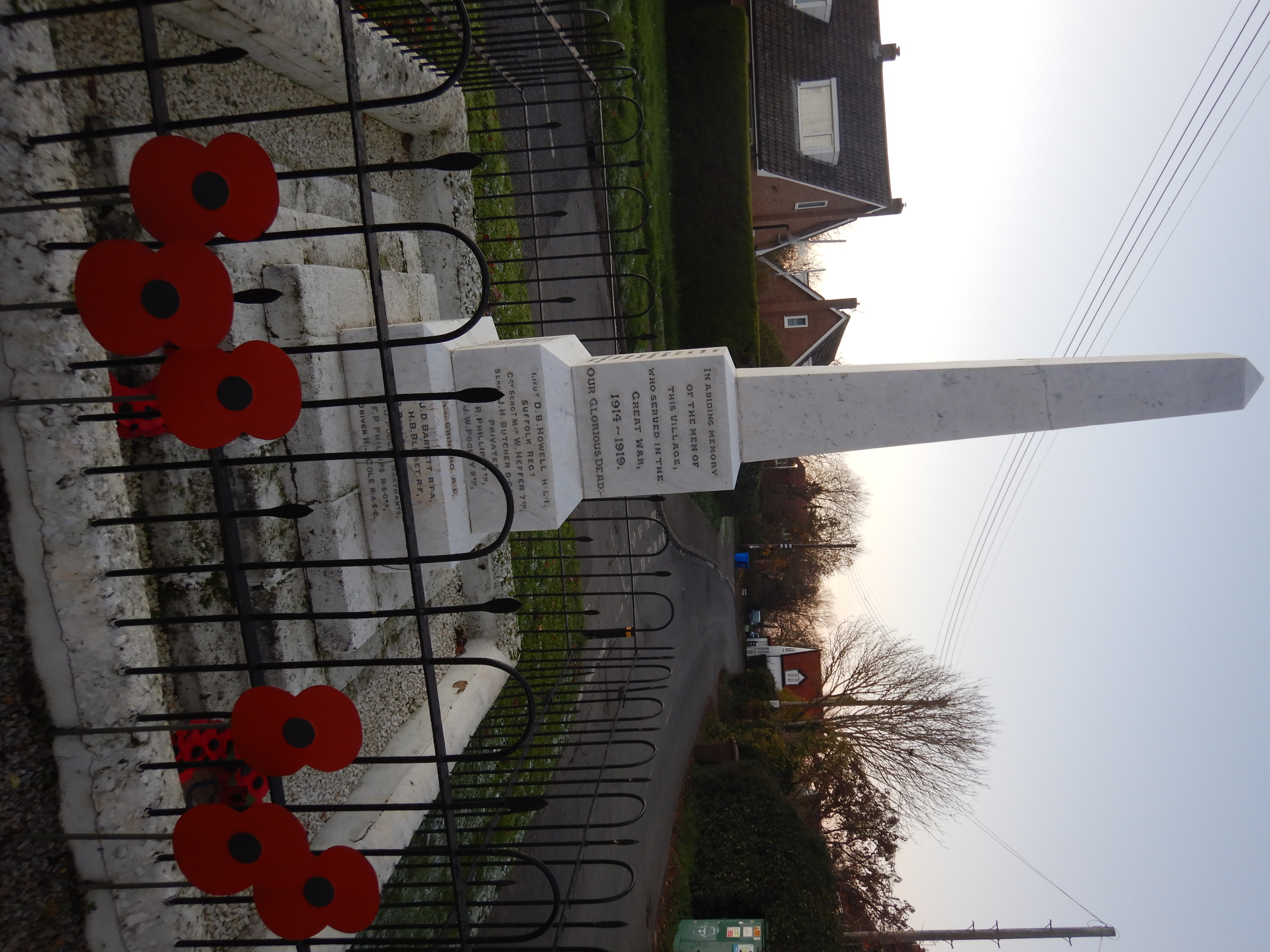  War Memorial (surrounded by black railings) looking at main inscription (as listed in article) on the West side.