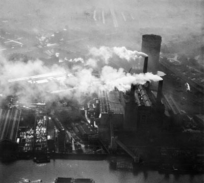 Smoke billowing from a darkened Battersea Power Station, Battersea, 1952