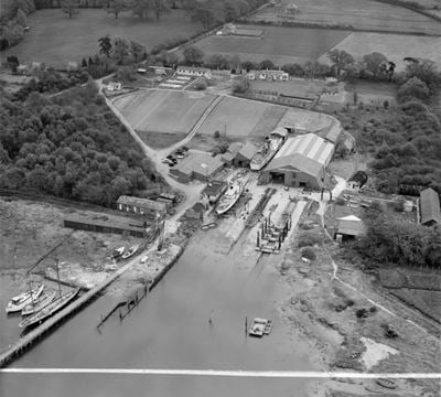 Solent Shipyards Ltd boatyard on the River Hamble, Sarisbury, 1952. This image was marked by Aerofilms Ltd for photo editing.