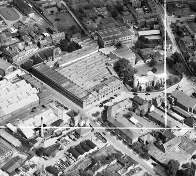 The Sexton, Son & Everard Ltd St Mary's Shoe Works alongside St Mary's Church, Norwich, 1953. This image was marked by Aerofilms Ltd for photo editing.