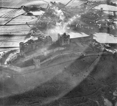 Bamburgh Castle overlooking the village, Bamburgh, 1950. This image has been produced from a print.