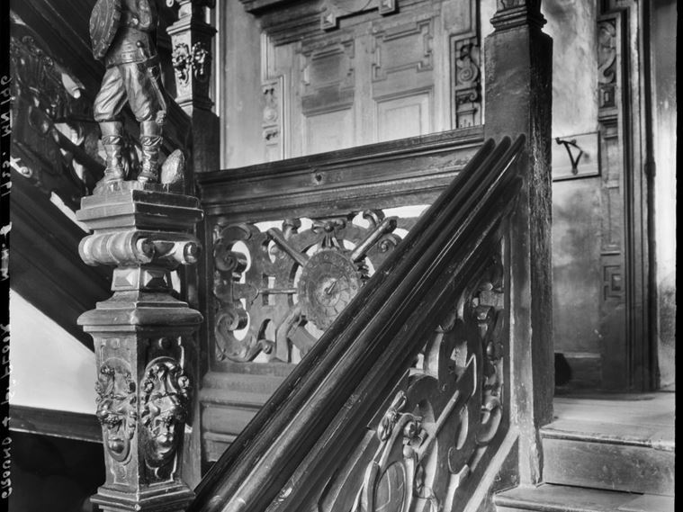 A view of the carved wooden staircase in Cromwell House, taken from the landing between the ground and first floors