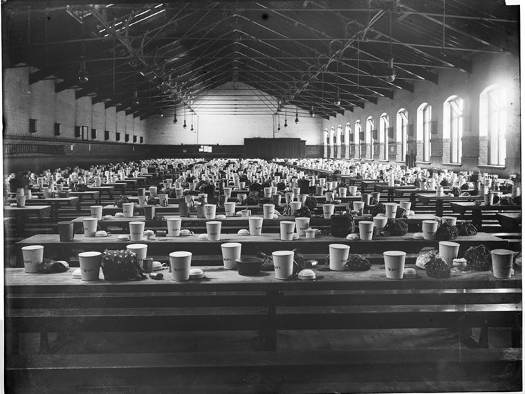The interior of the Lancashire and Yorkshire Cafe Dining Rooms showing rows of trestle tables with bags and drinking vessels arranged on top