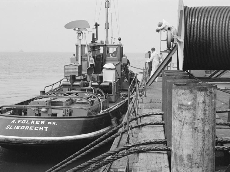 A tug moored alongside a towing barge, used during the launch of the Northcoates pipeline